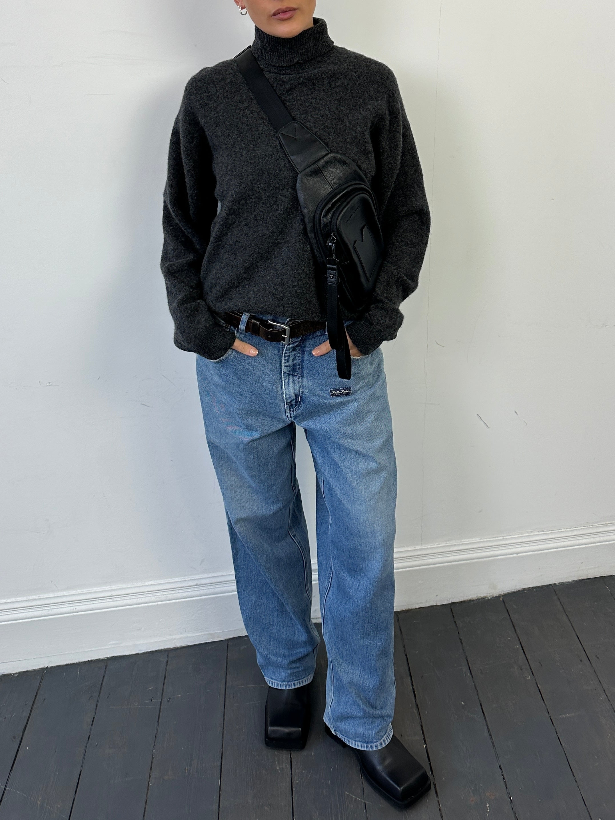 Lacoste pure wool roll neck jumper in size M, featuring a classic knit design and ribbed collar in a neutral color.