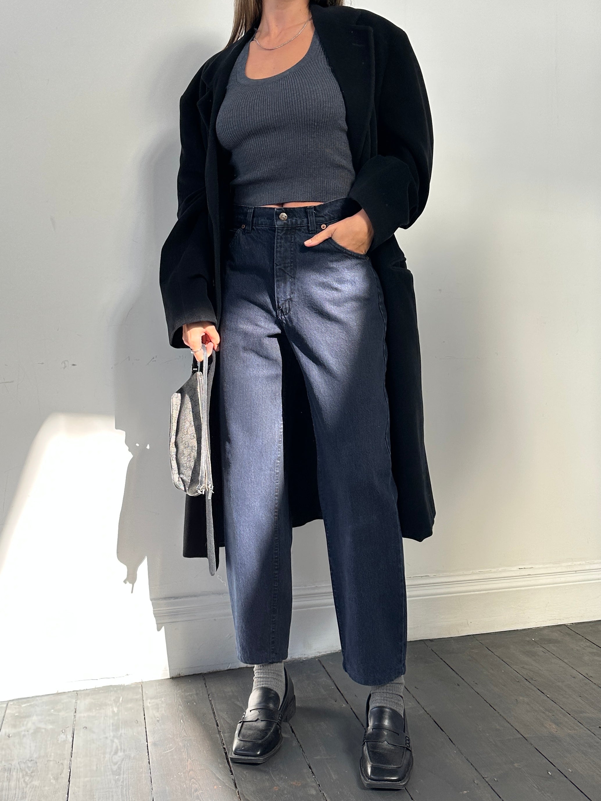 Valentino tapered high-waisted denim jeans in W28 displayed on a hanger, showcasing classic blue wash and stylish fit.
