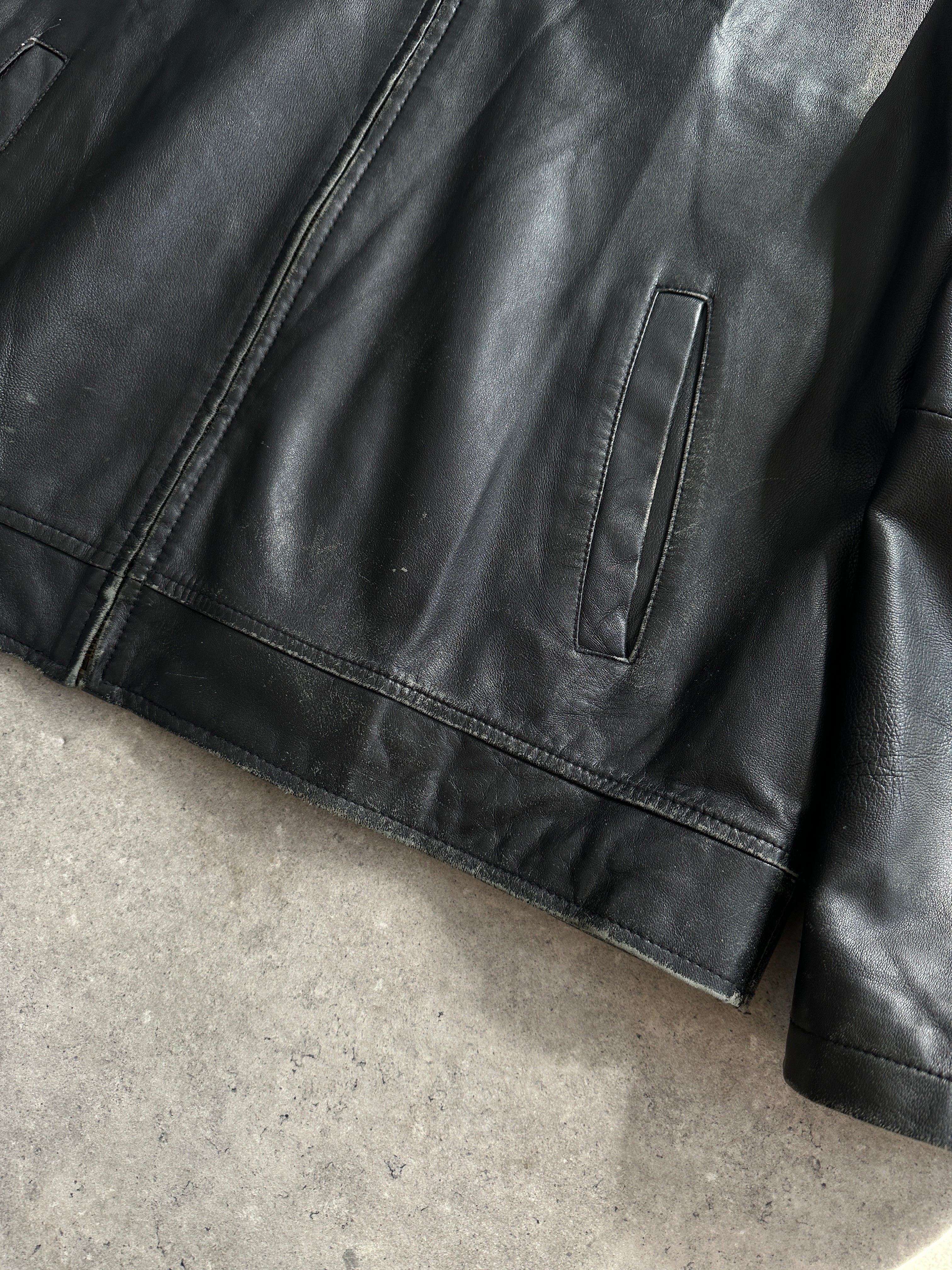 Conbipel minimal leather jacket in size L, featuring sleek design and smooth black leather, displayed on a hanger.