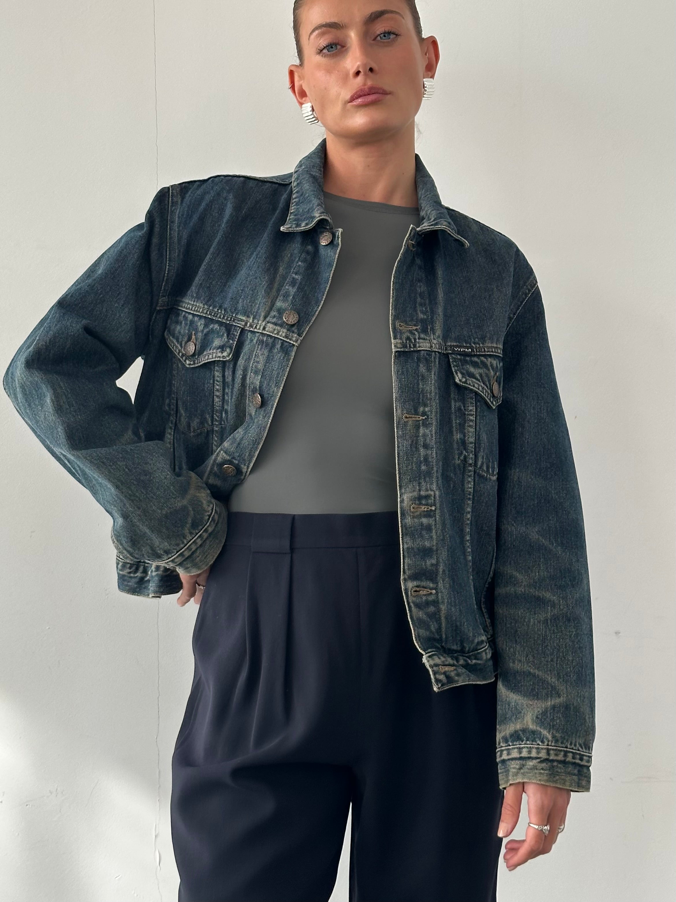 Vintage Italian washed denim jacket in M/L size with classic design and faded blue finish, casual outerwear for men and women.