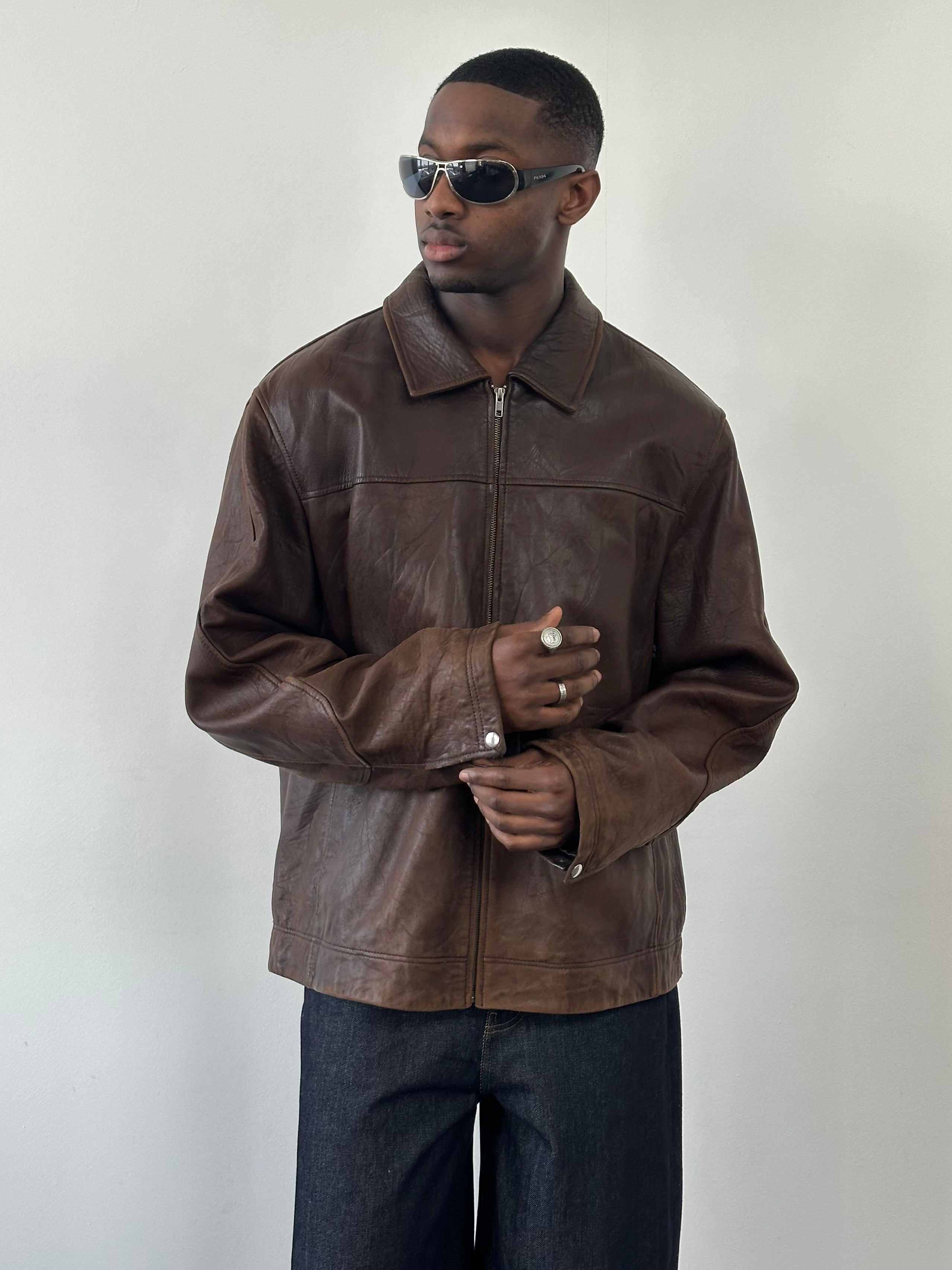 Vintage 1990s distressed leather jacket, XXL size, with rugged texture and classic design, suitable for stylish casual wear.