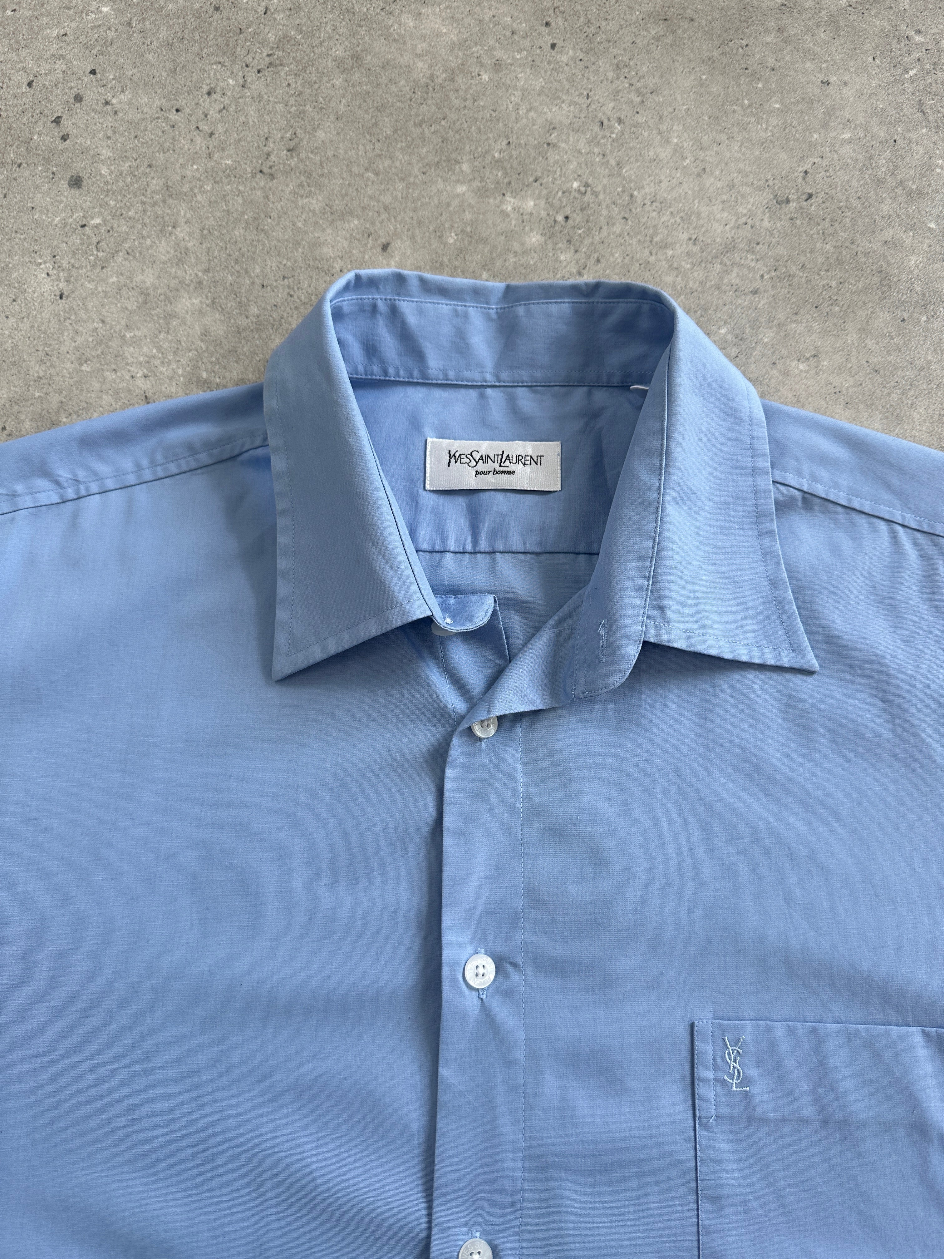 Yves Saint Laurent Pour Homme cotton short sleeve logo shirt in size L/XL, white with YSL branding on the chest.