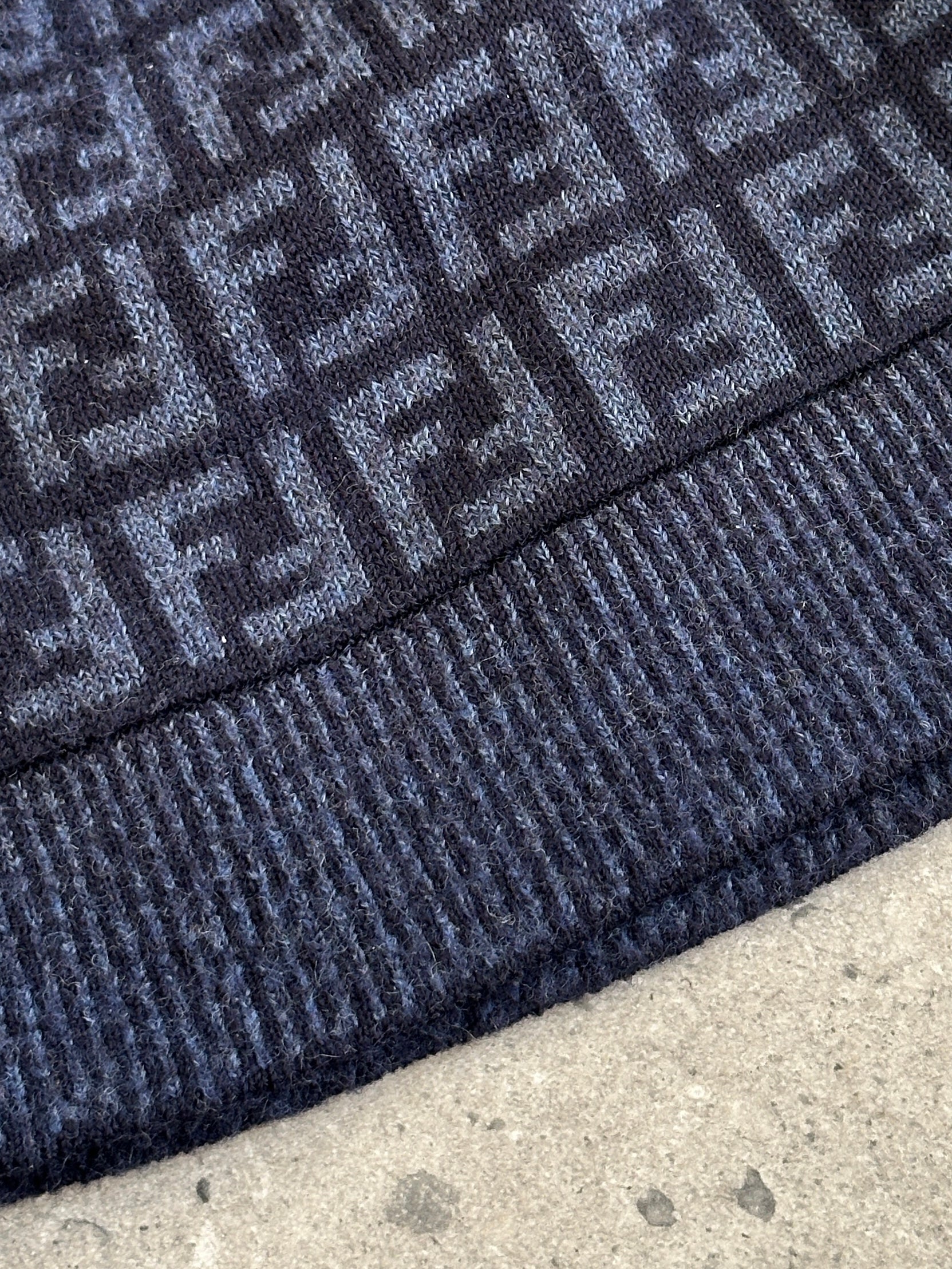 Fendi FF monogram print beanie hat with ribbed knit fabric, featuring signature designer logo and stylish winter headwear.