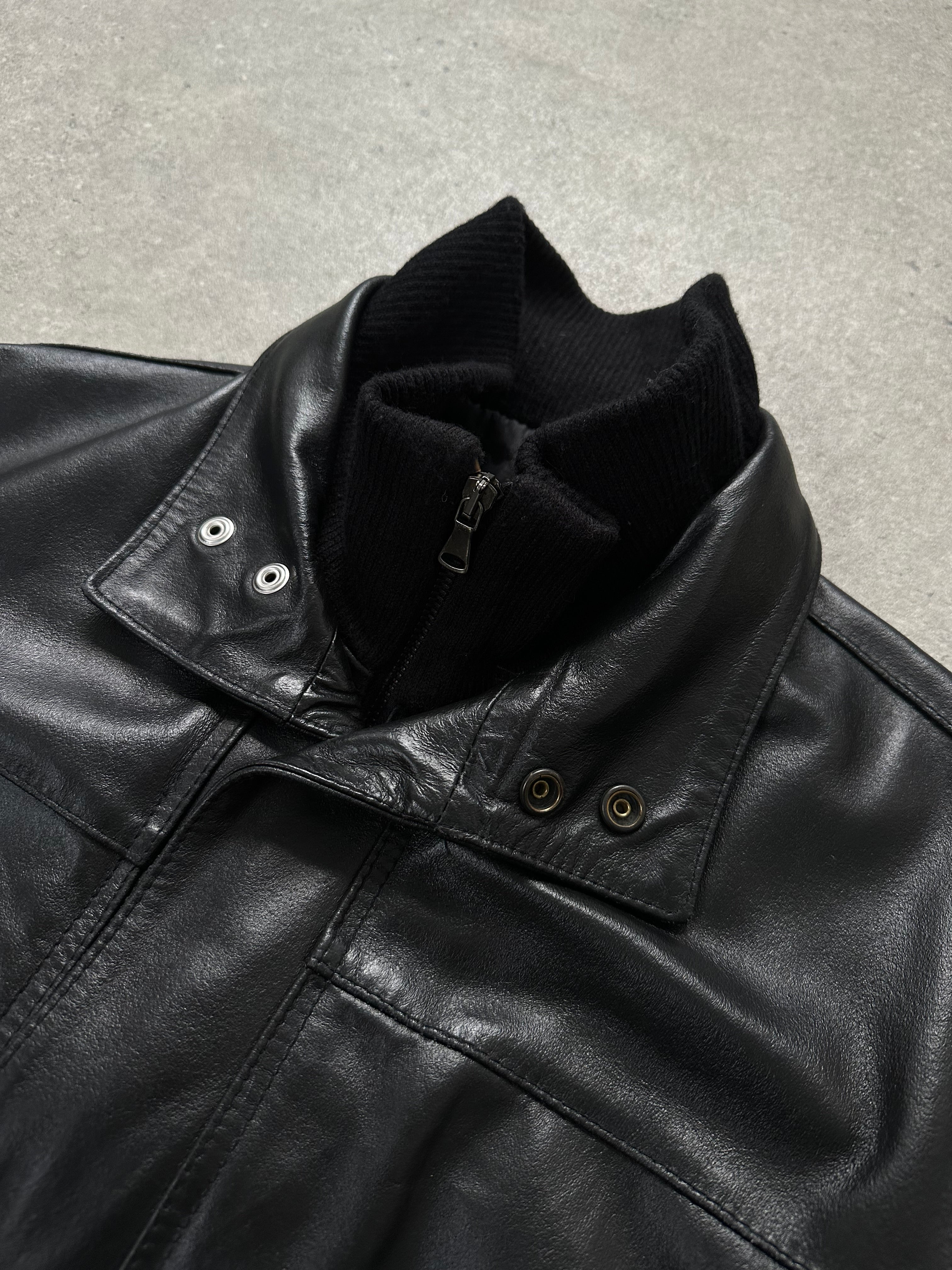 Vintage Italian 1990s leather trench coat with funnel neck, oversized fit, classic vintage leather jacket style.