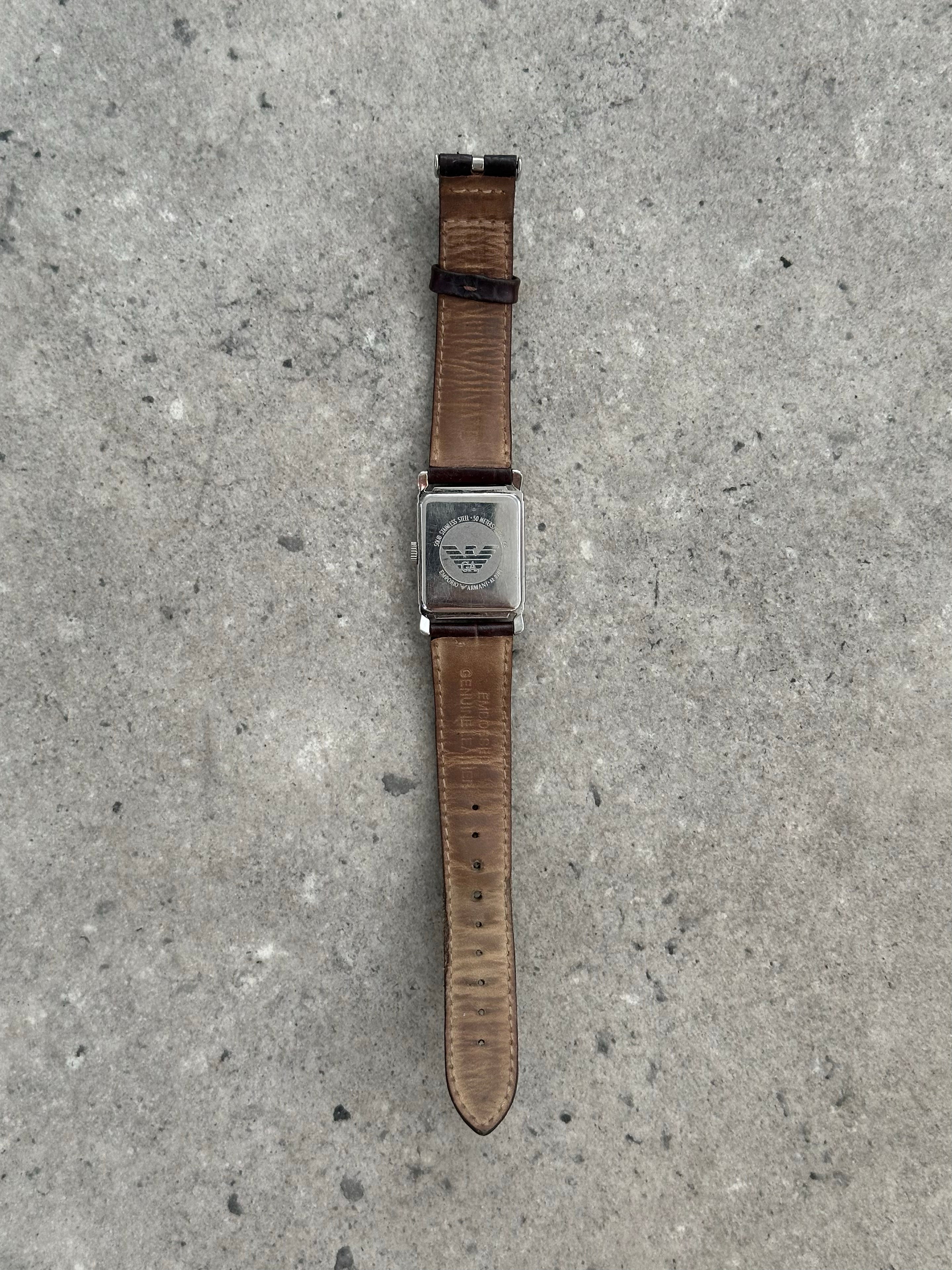 Emporio Armani leather logo watch with round dial and classic design, featuring the Armani brand logo on the strap.