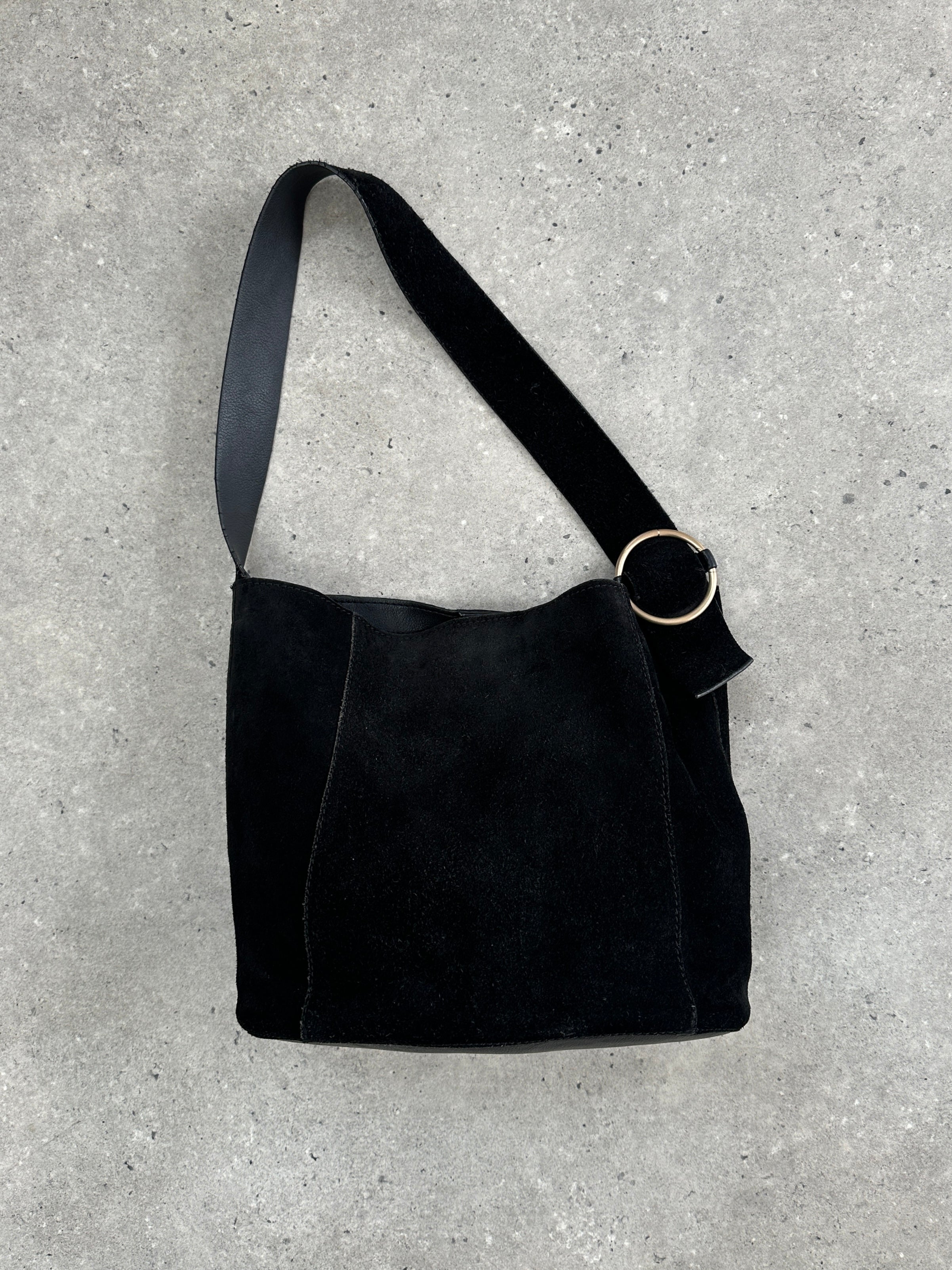 Vintage Maison de Nimes suede bucket bag with drawstring closure and adjustable shoulder strap, stylish and compact accessory.