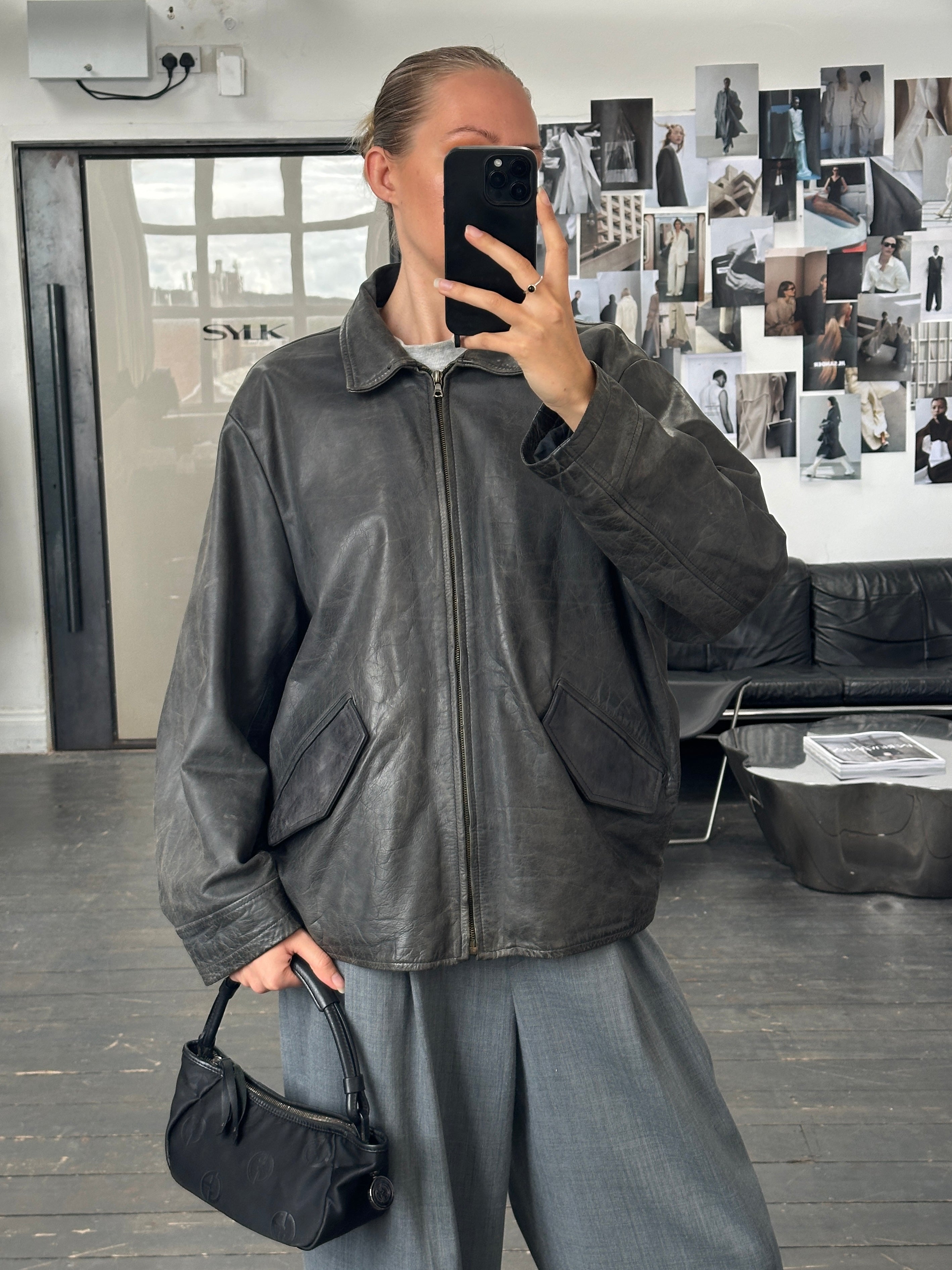 Vintage 1990s boxy leather jacket in aged brown leather, size L/XL, with classic collar and front button closure.