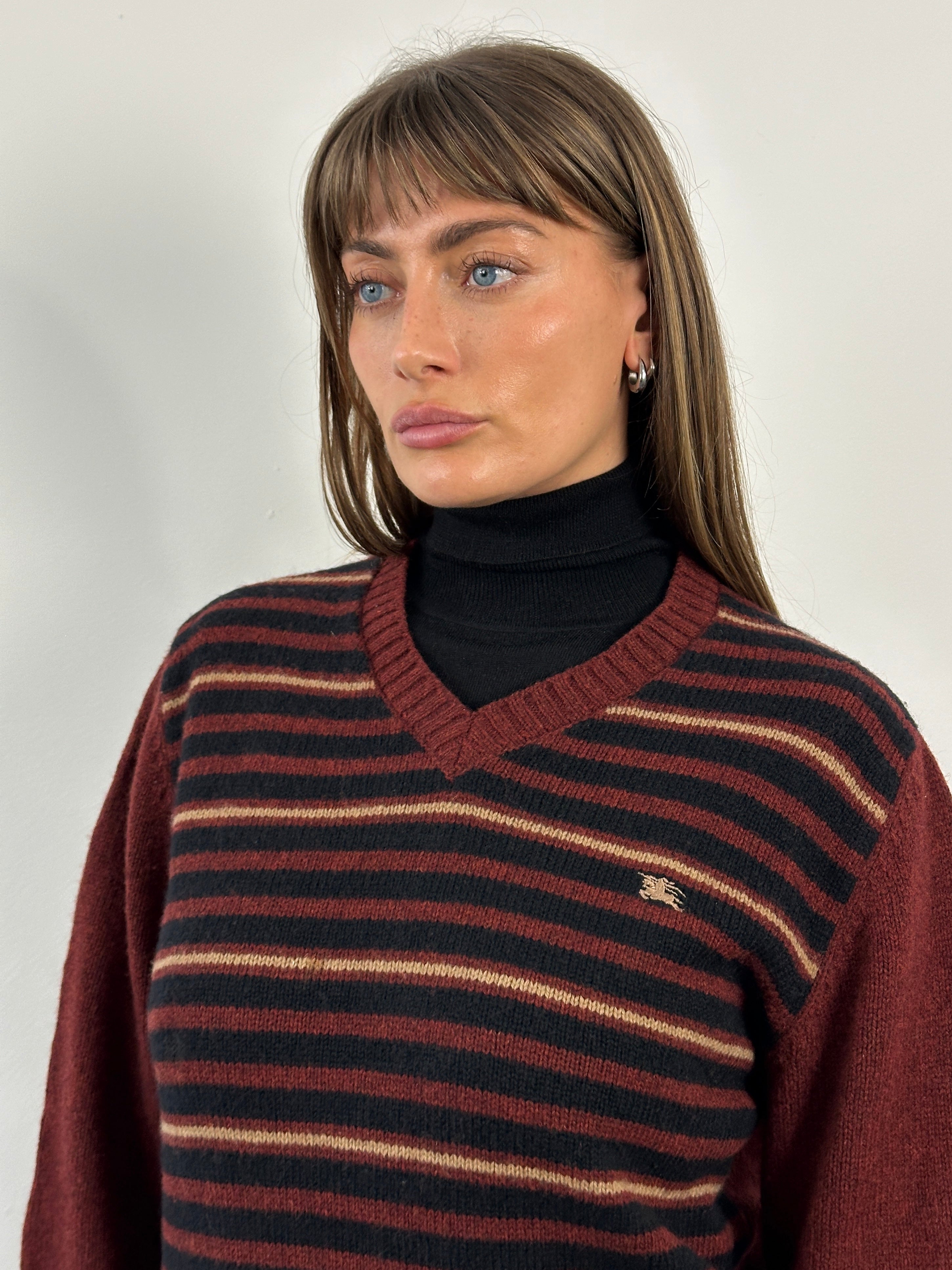 Burberry London 2000s lambswool V-neck striped jumper in size M/L, featuring classic Burberry pattern and cozy knit texture.