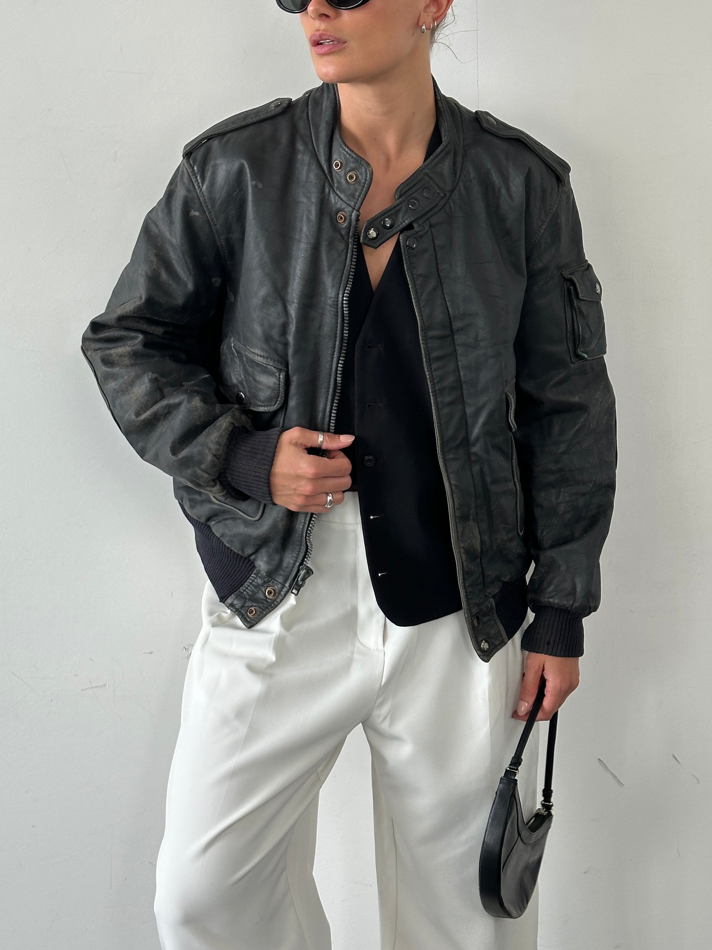 Vintage distressed leather bomber jacket in size M/L, featuring rugged style and classic design.