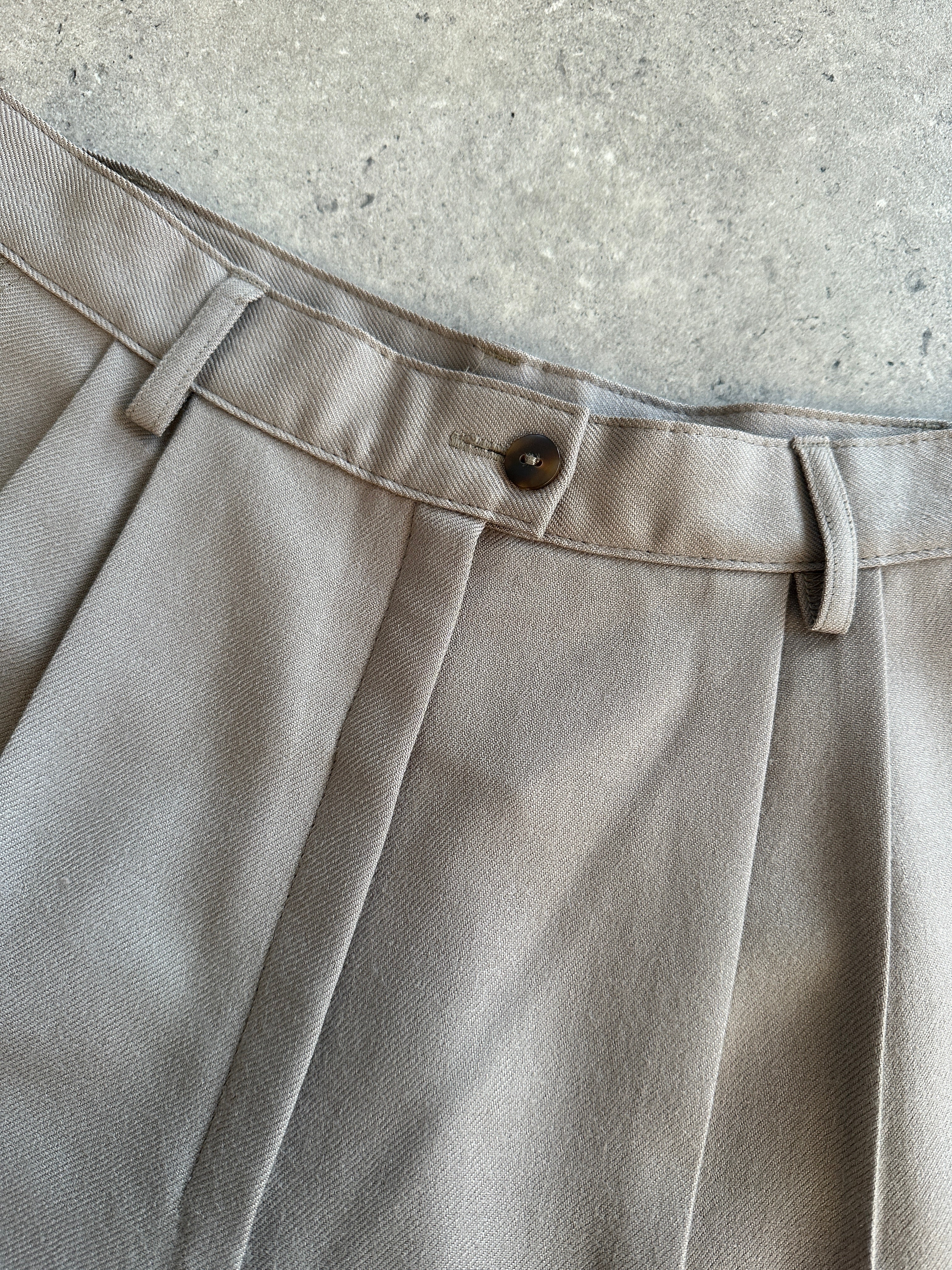 Italian vintage high-waisted wool trousers in size W26, showcasing classic tailored design and rich fabric texture.