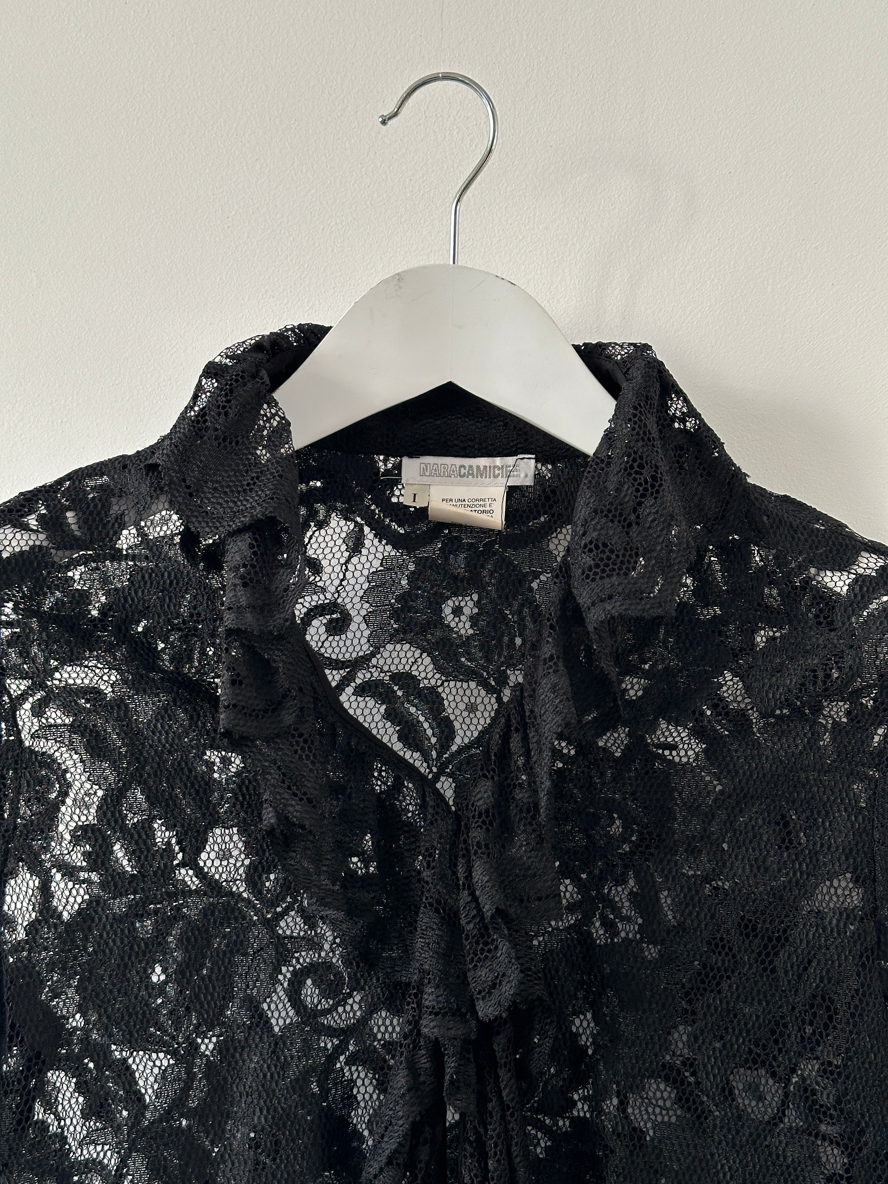 Vintage lace ruffled shirt in size S/M, featuring delicate lace detailing and feminine ruffles, displayed on a neutral background.