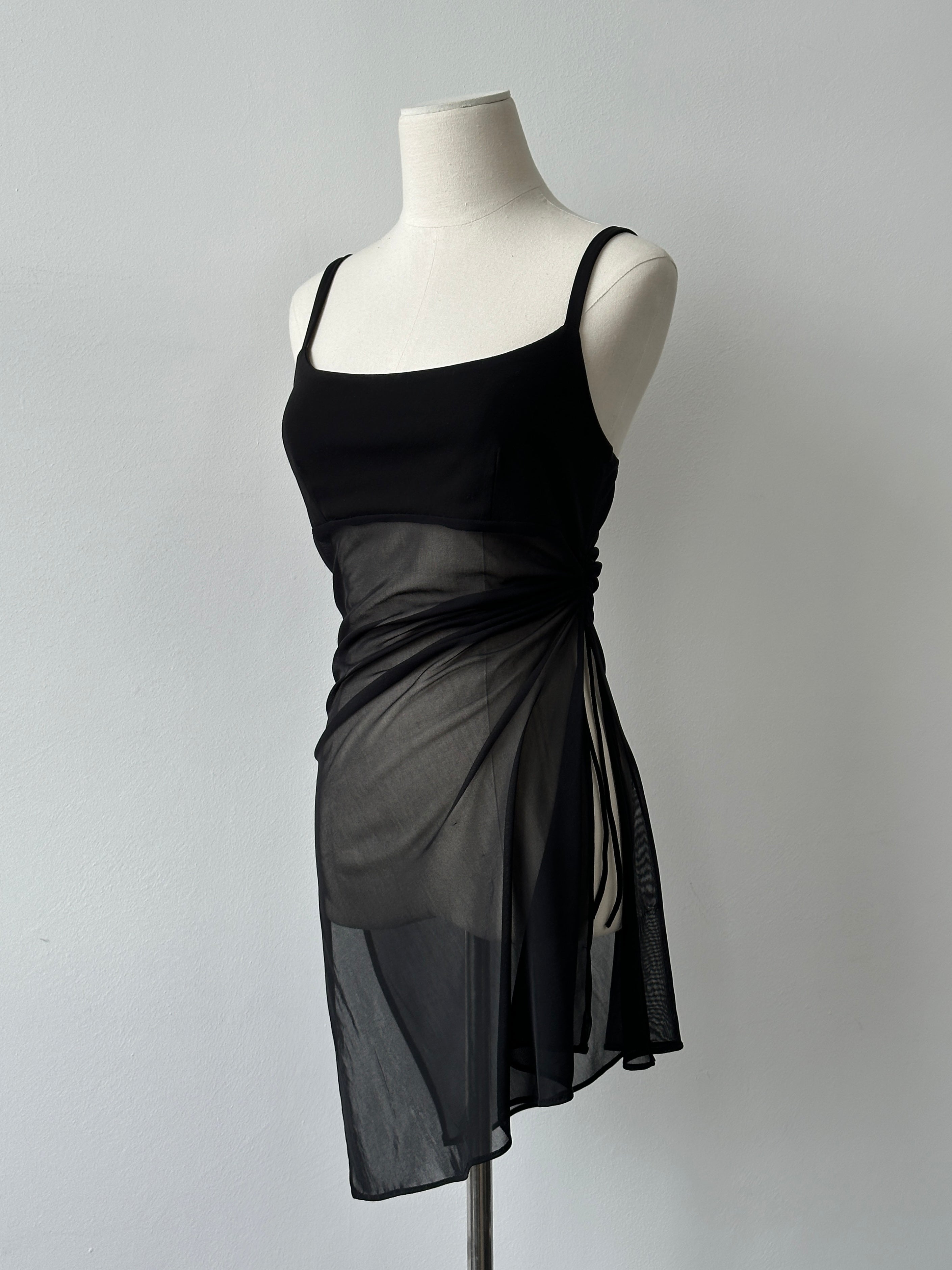 Vintage 1990s French sheer sleeveless top, lightweight and stylish, with delicate fabric and classic design.