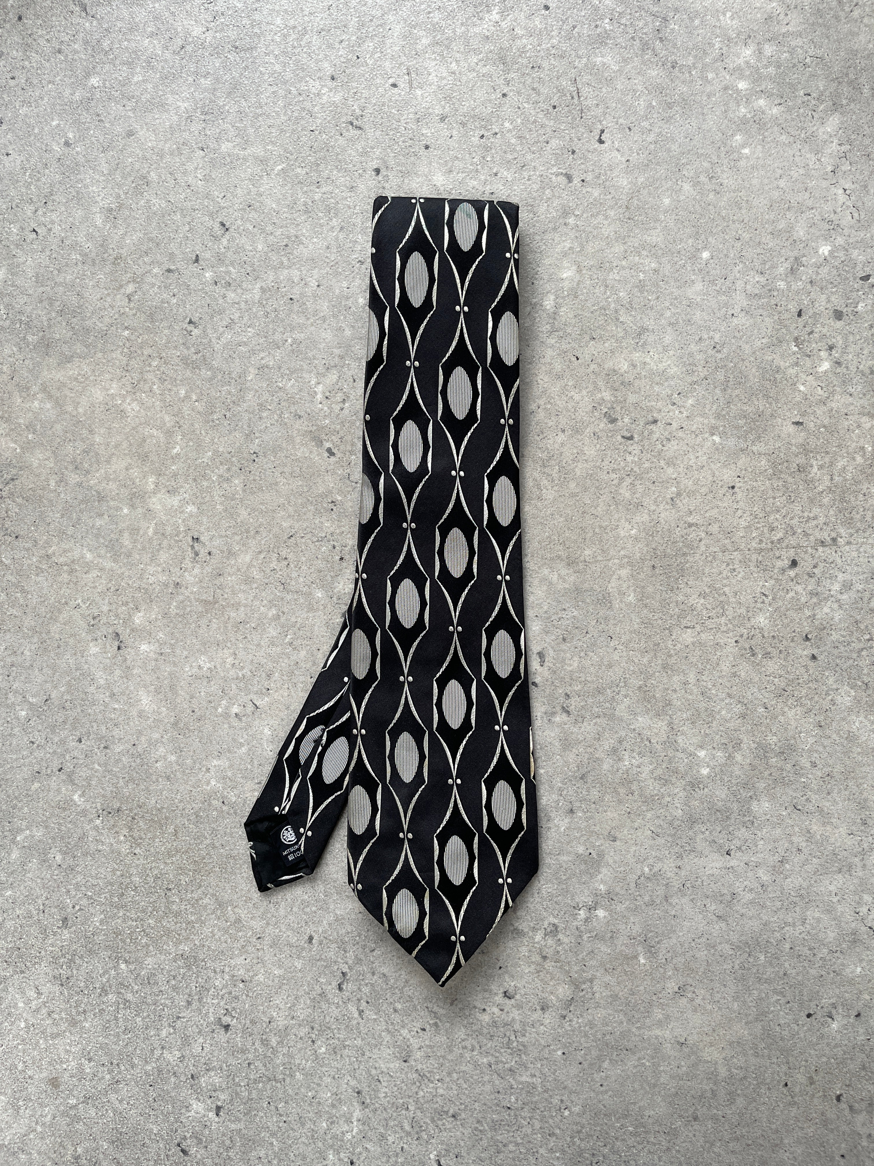 Yves Saint Laurent Paris 1990s pure silk printed tie with intricate patterns, showcasing luxury and classic elegance.