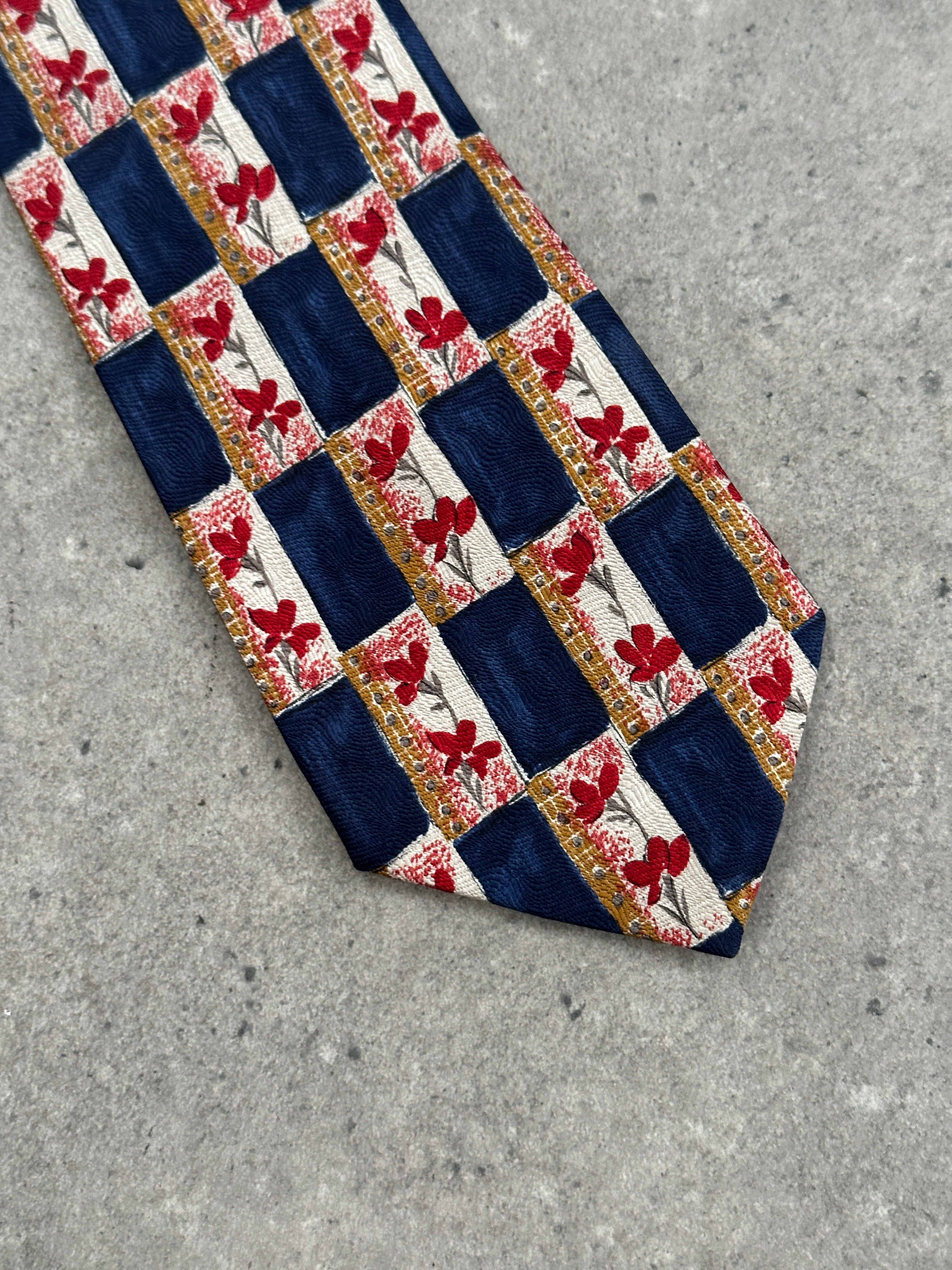 Yves Saint Laurent 1990s pure silk logo tie with classic design, featuring the iconic YSL monogram pattern on smooth silk fabric.