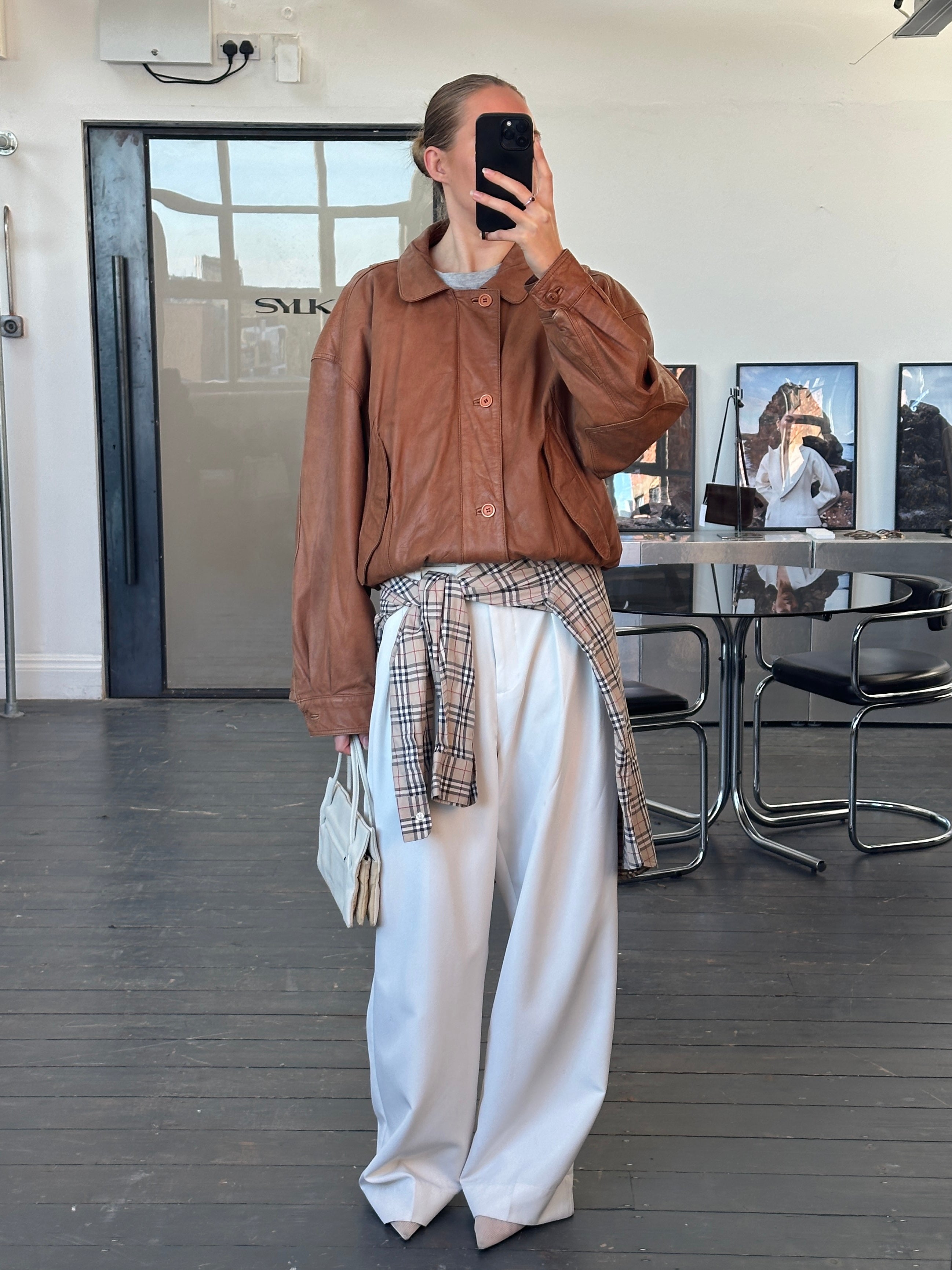 Vintage leather bomber jacket from the 1980s, size large, featuring classic design and distressed leather details.