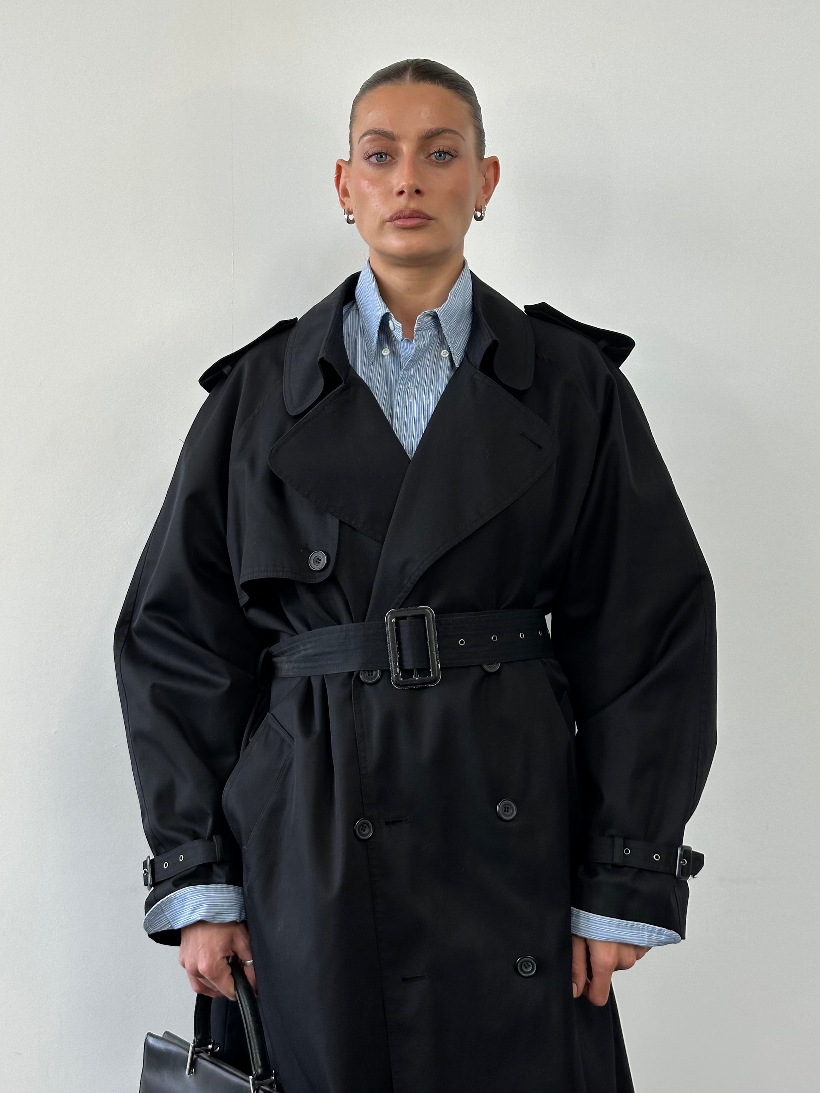 Vintage double-breasted belted trench coat in XL, classic style with lapels and button details, shown on a hanger.