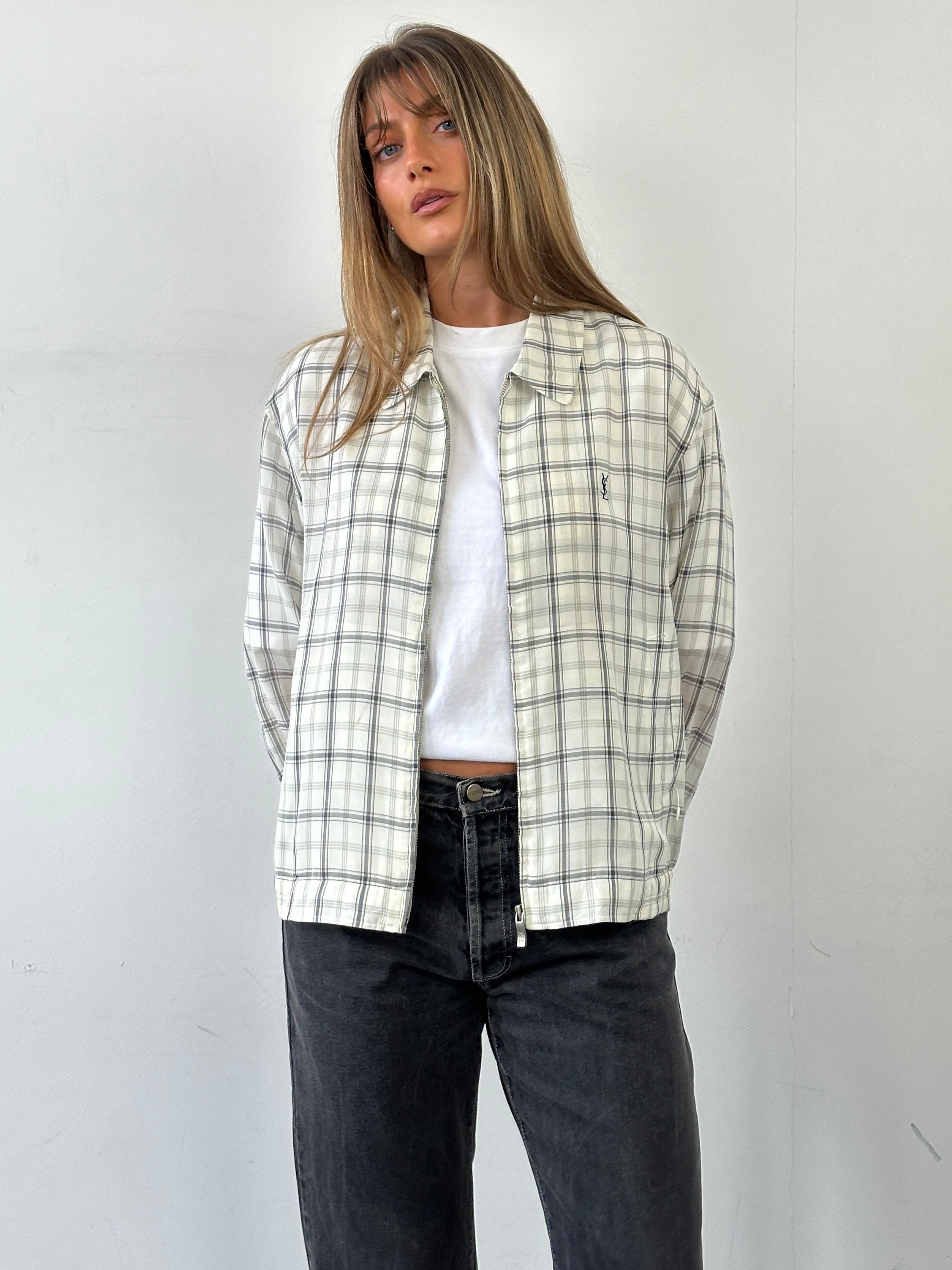 Yves Saint Laurent Pour Homme check logo bomber jacket in black and white, front view showing distinctive logo pattern and collar.