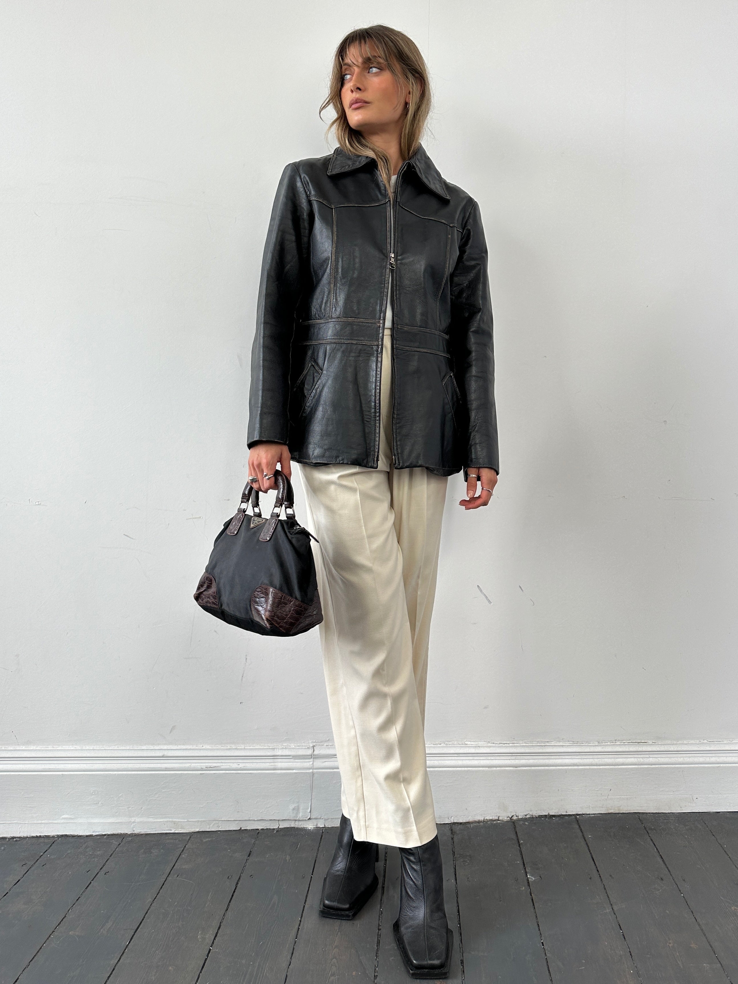 Conbipel double zip waisted leather jacket in black, featuring a stylish design with dual front zippers and a fitted silhouette.