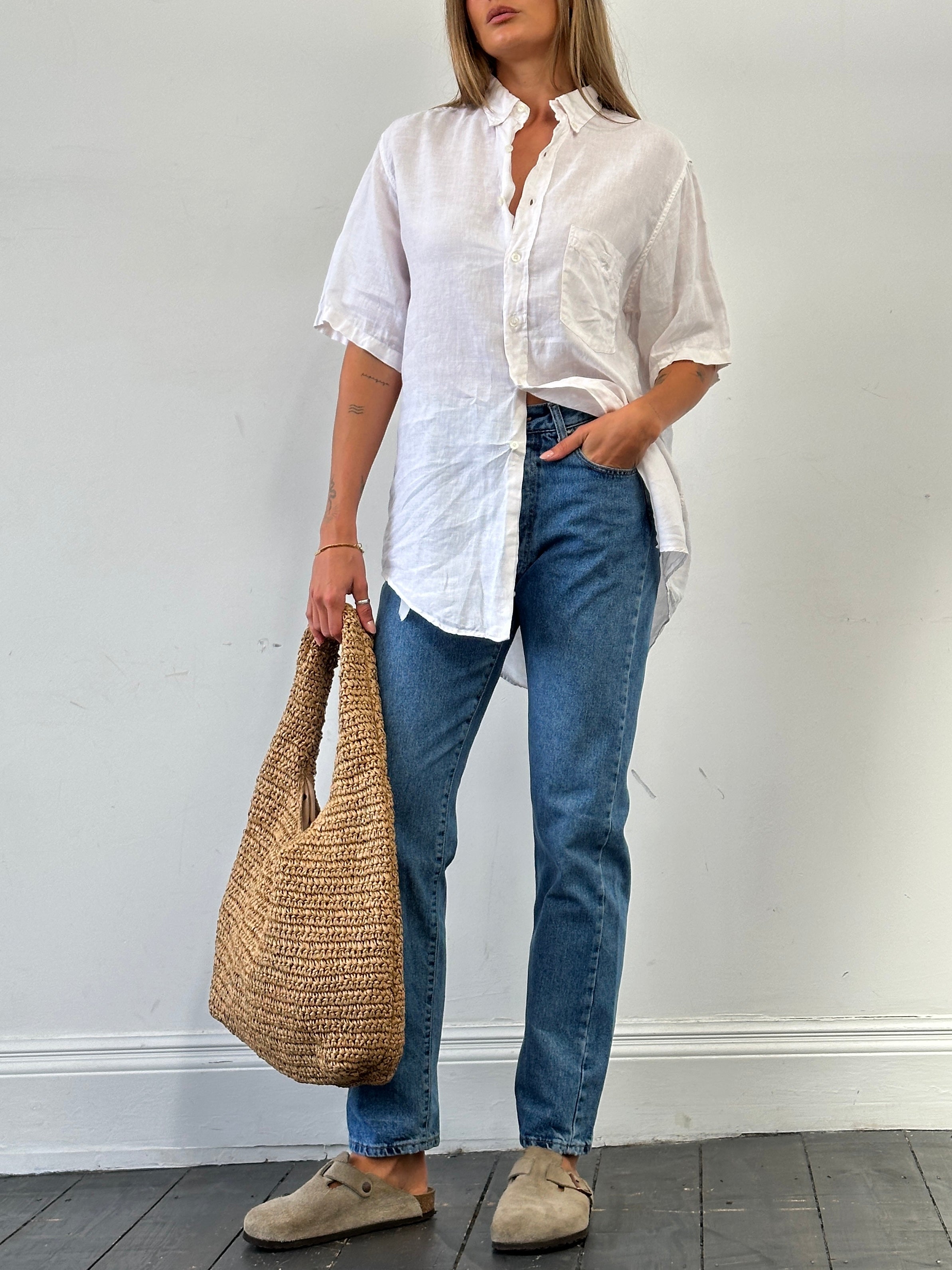 Armani Jeans mid wash tapered leg high waisted denim jeans with W28 size, displayed on a flat surface.
