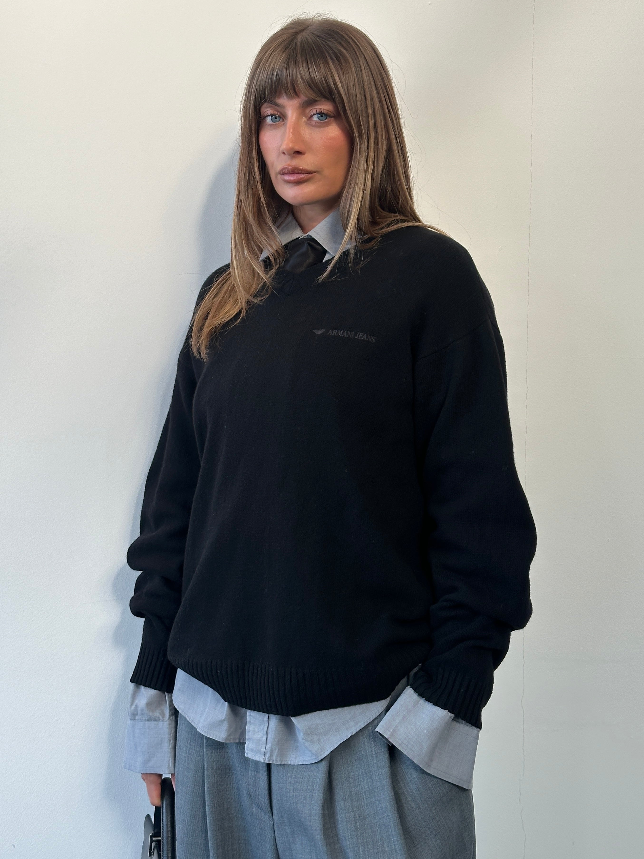 Armani Jeans 1990s wool V-neck knitted jumper in size L/XL, featuring a logo design, modeled on a person.