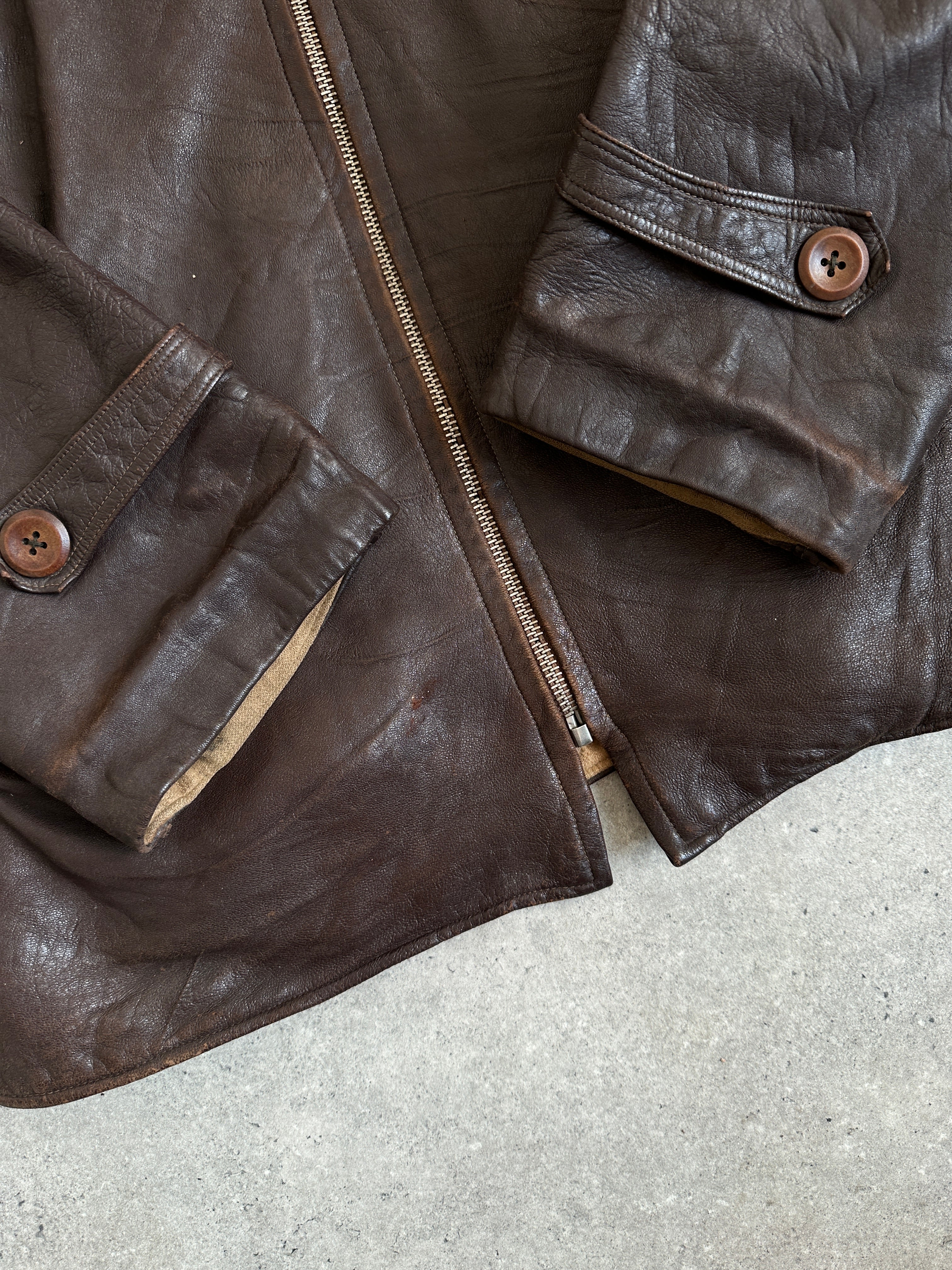 Vintage distressed mid-length leather jacket in XL size with a rugged appearance and classic design, made by Vintage.