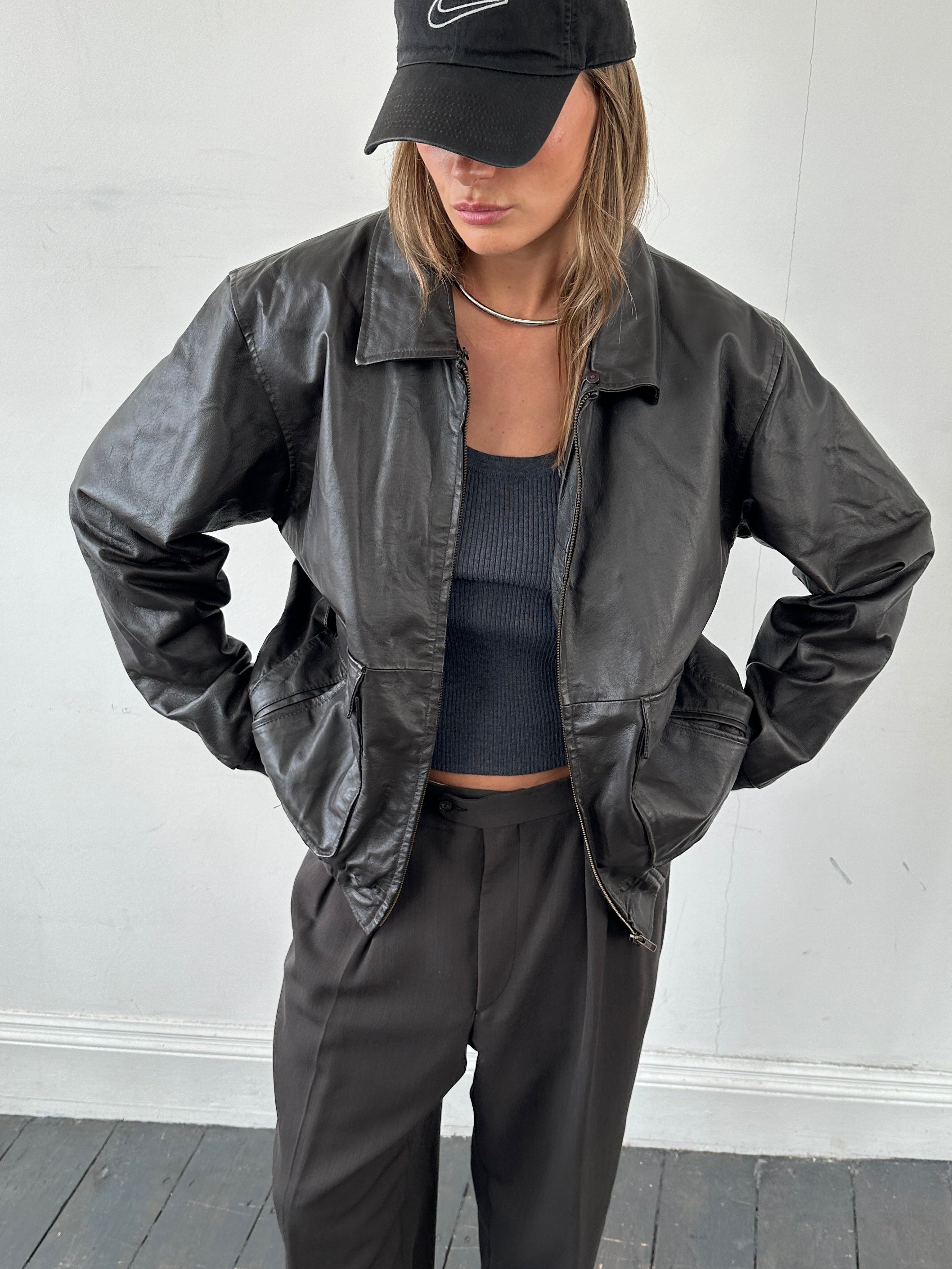 Vintage smooth leather bomber jacket in size large, featuring classic design and durable construction.