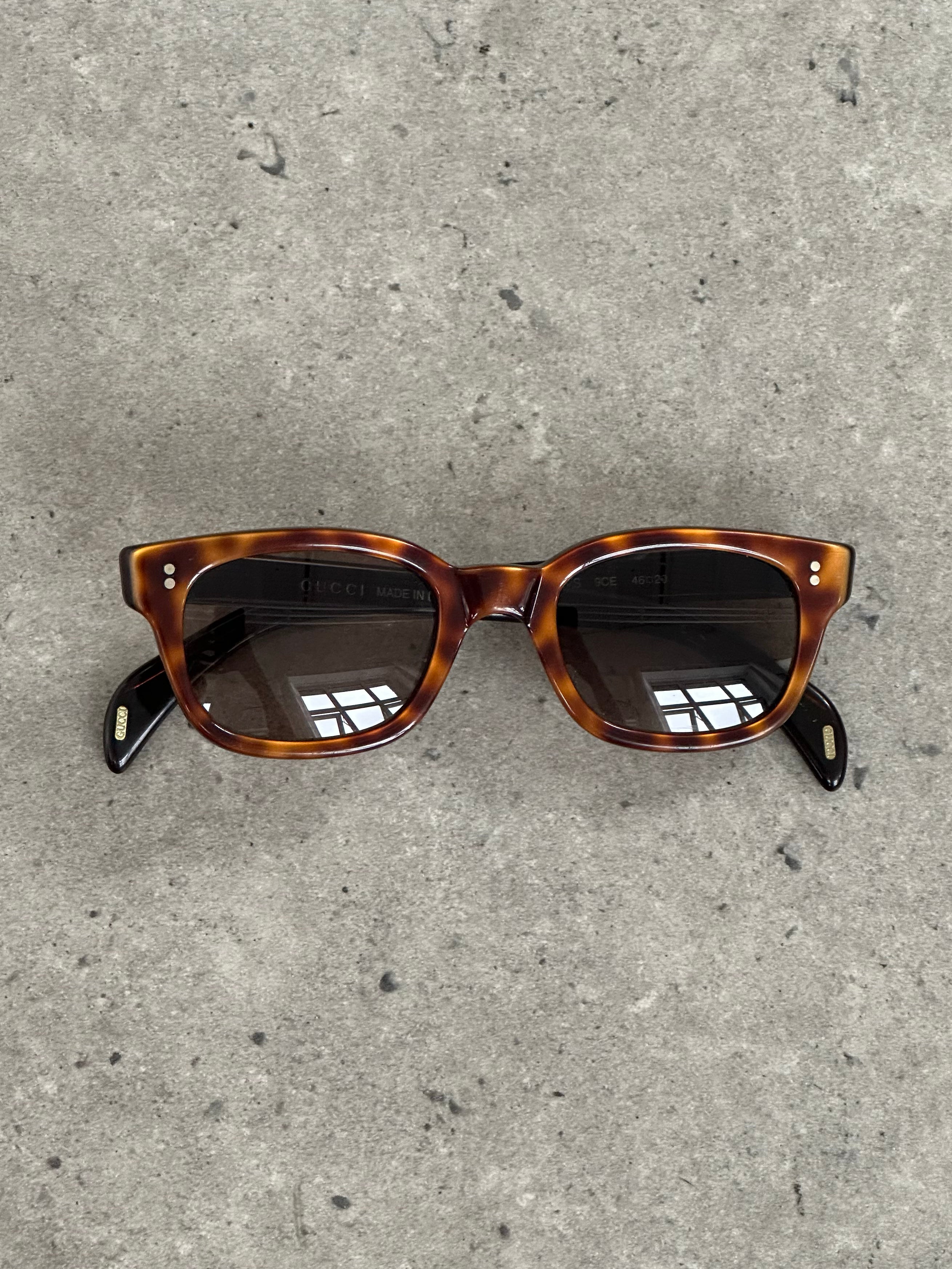 Gucci 2000s Tom Ford tortoiseshell rectangle logo sunglasses with classic design and branding.
