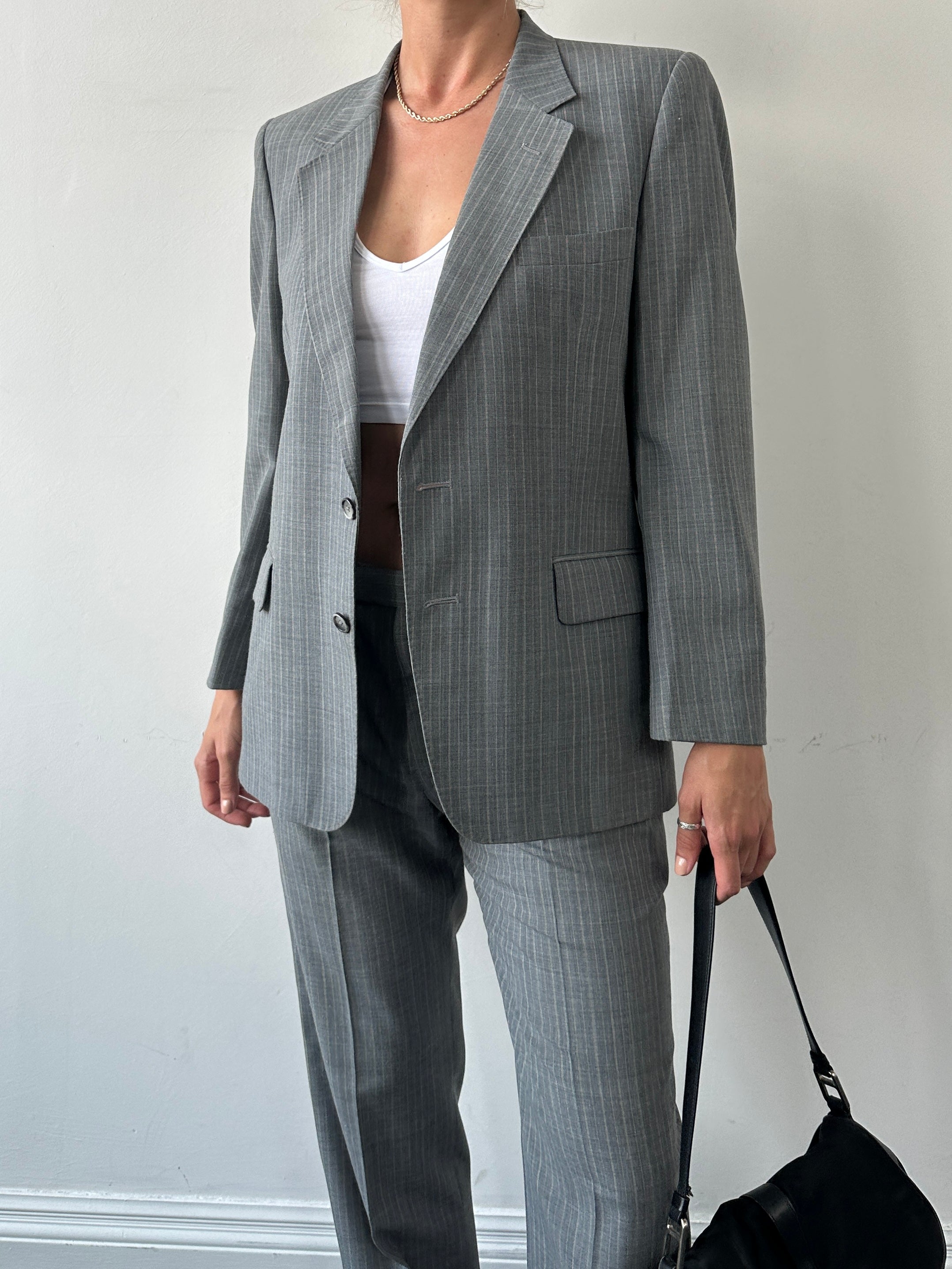 Christian Dior Monsieur pinstripe wool single-breasted suit, size 40S/W34, displayed on a hanger with tailored fit and classic design.