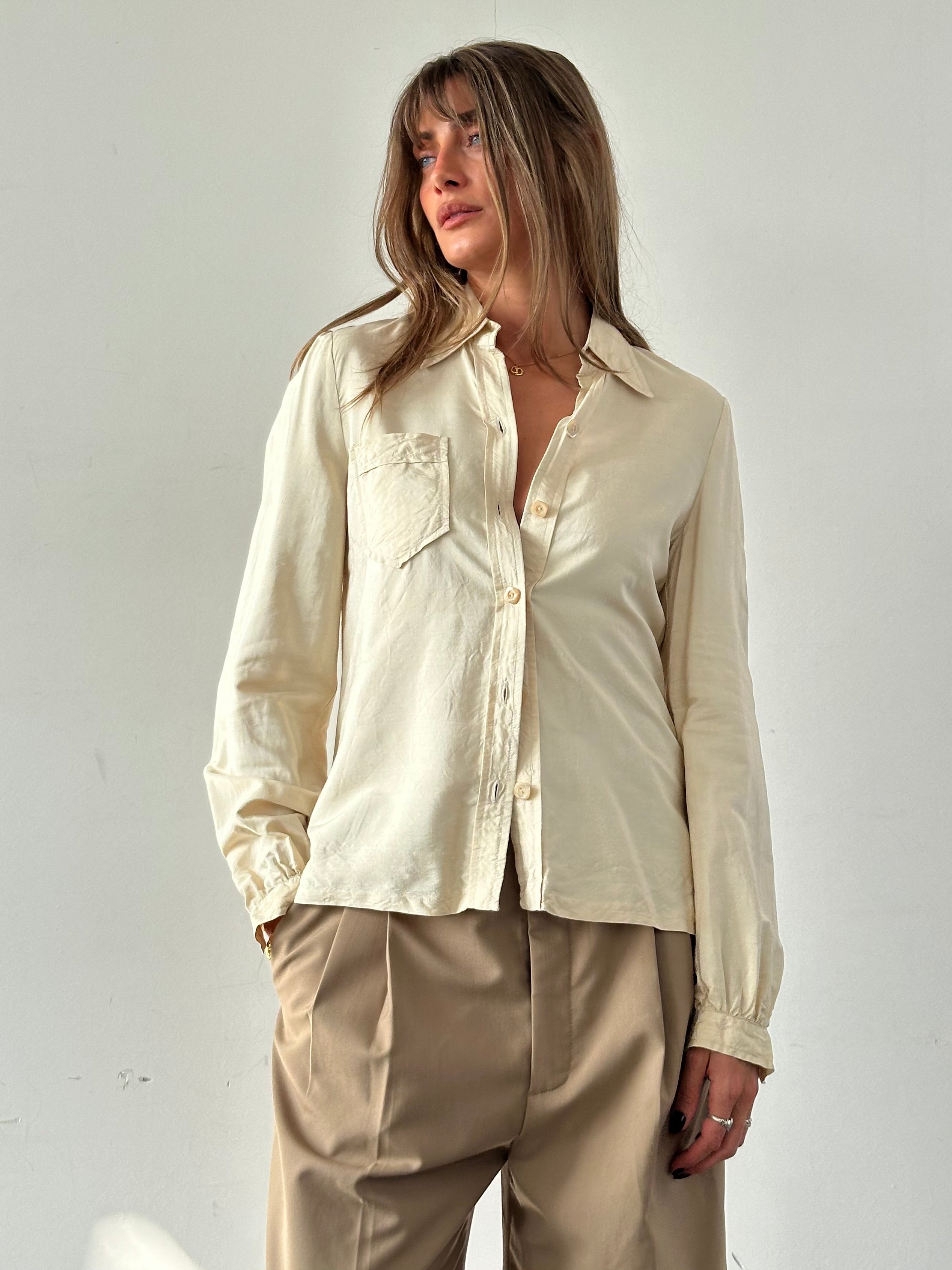Vintage silk button-up shirt in size small, featuring a classic collar and elegant fabric with a subtle sheen.