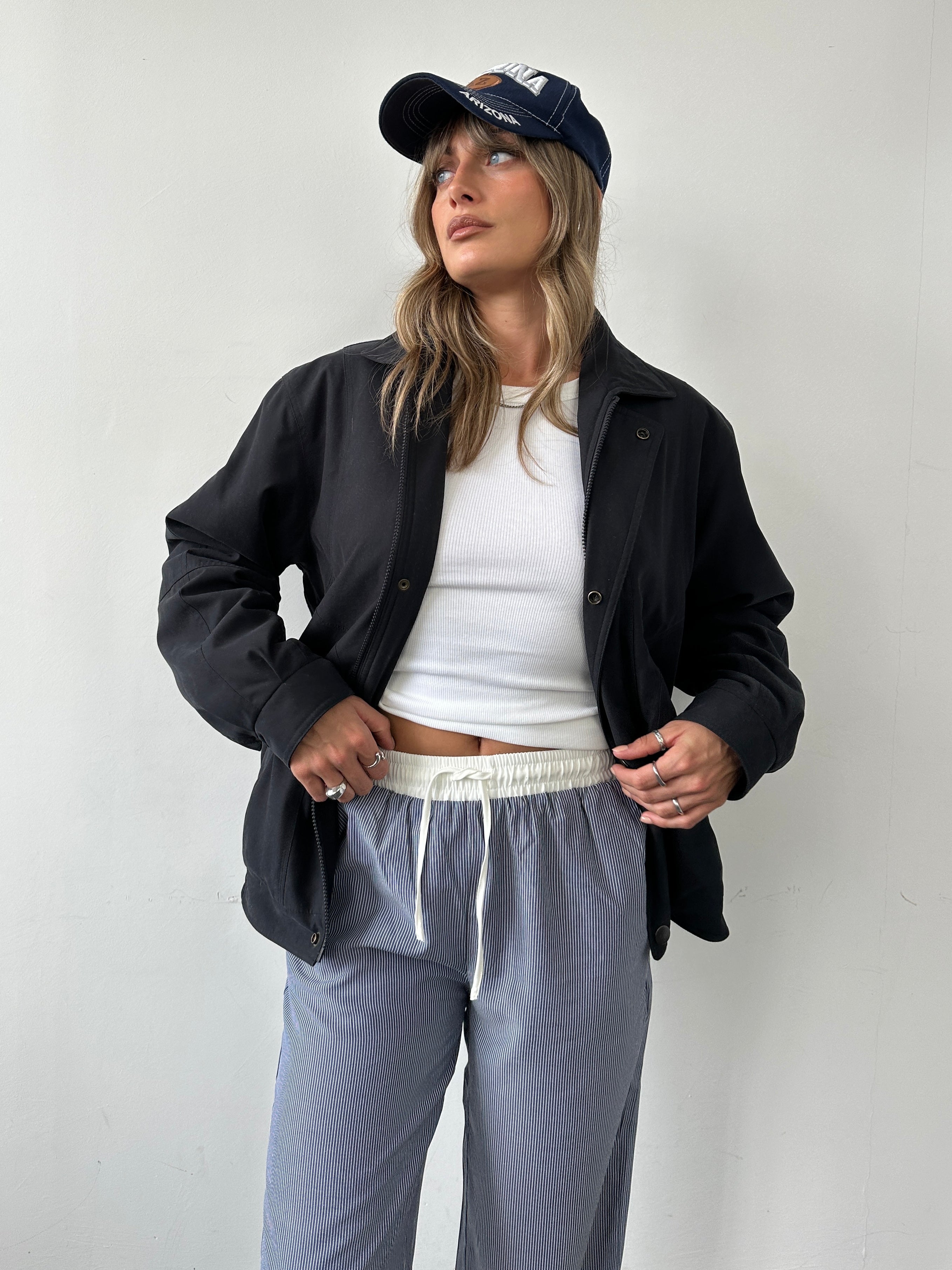 Vintage padded bomber jacket in size large, featuring a classic design with a quilted exterior and ribbed cuffs and collar.