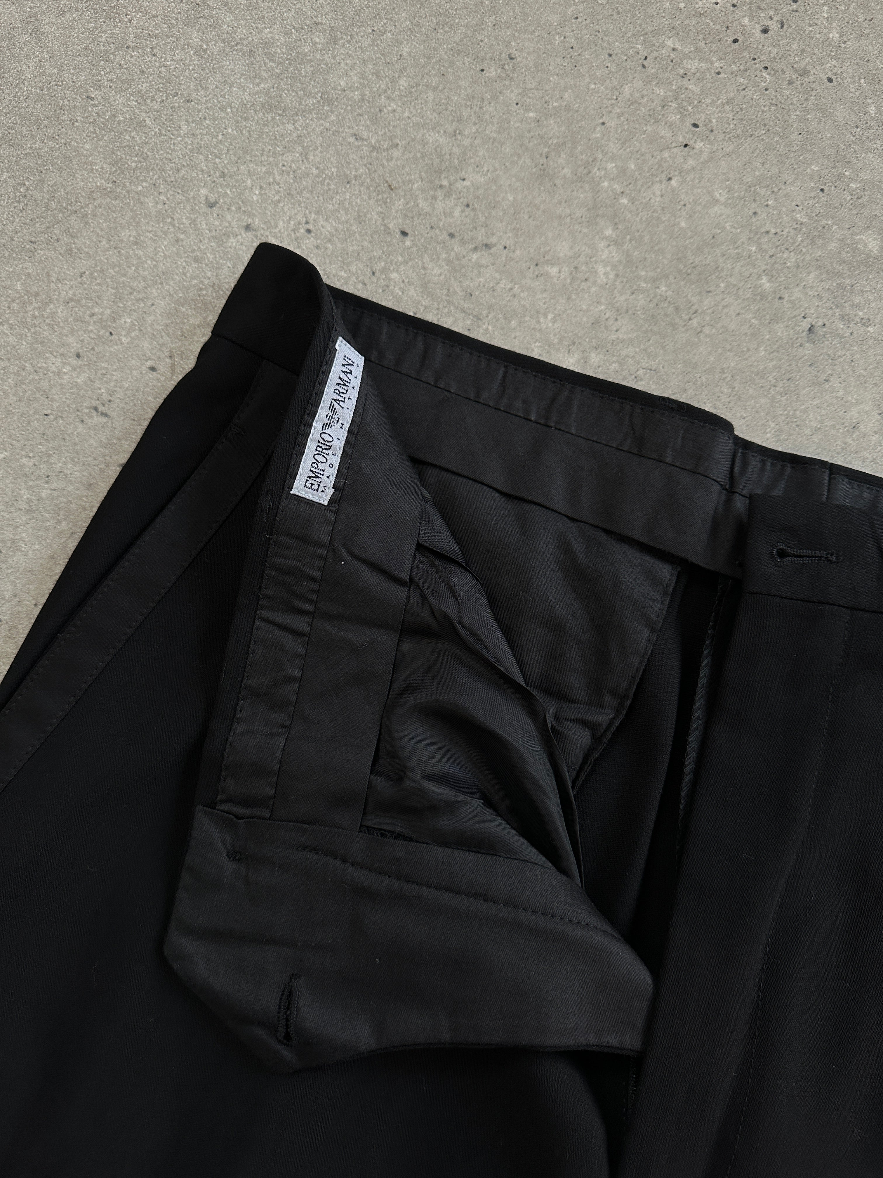 Emporio Armani 1990s tailored men's pure wool tuxedo trousers in size W34, displaying a classic black fit with sharp tailoring.