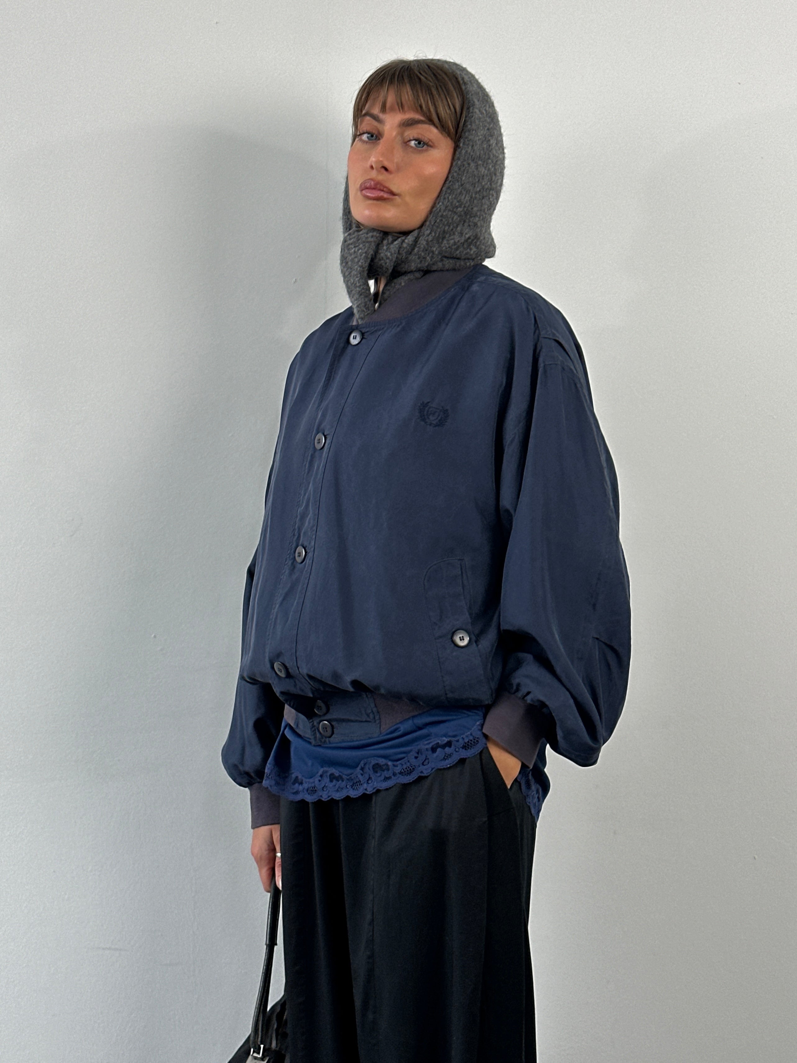 Vintage 1990s pure silk bomber jacket, size large, displaying a sleek, shiny vintage bomber jacket with a classic design and silky finish.