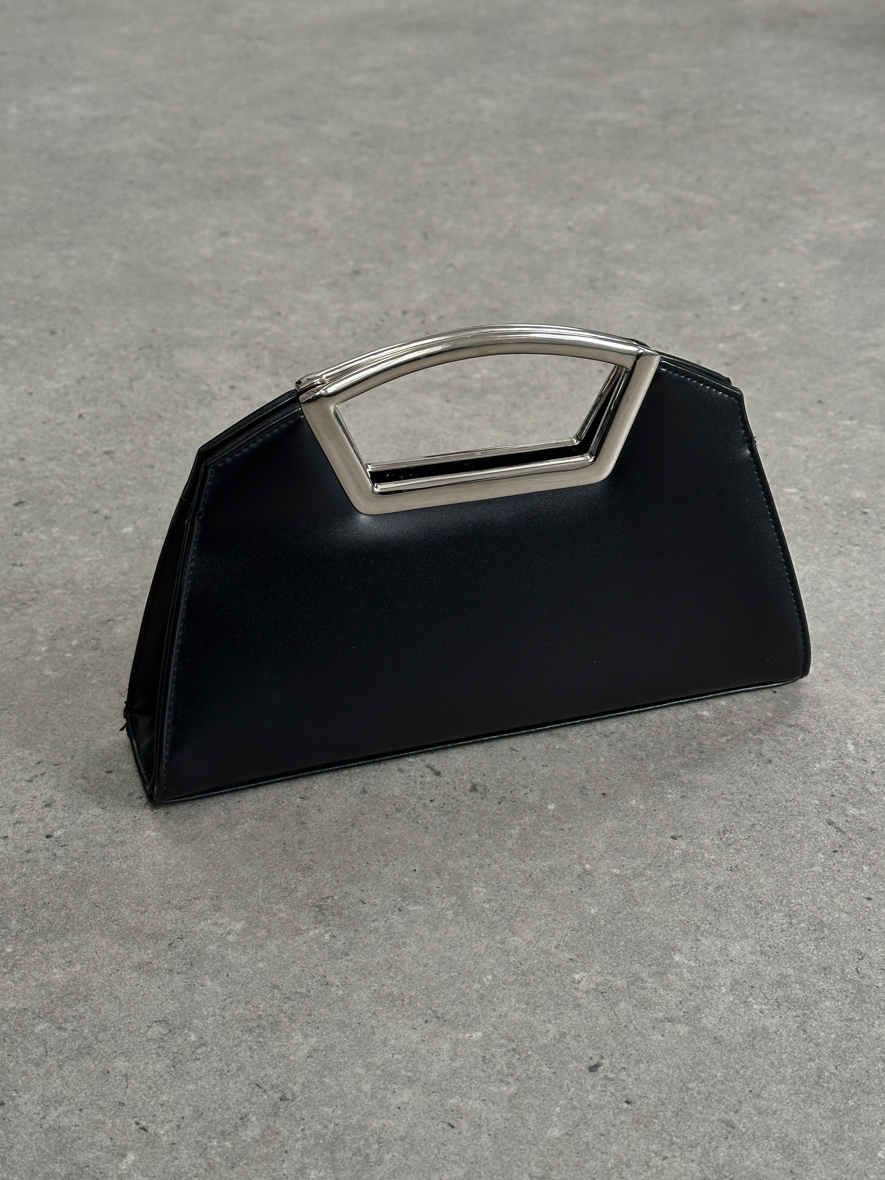 Vintage leather chrome crossbody clutch bag with sleek design and adjustable strap, perfect for stylish everyday use.