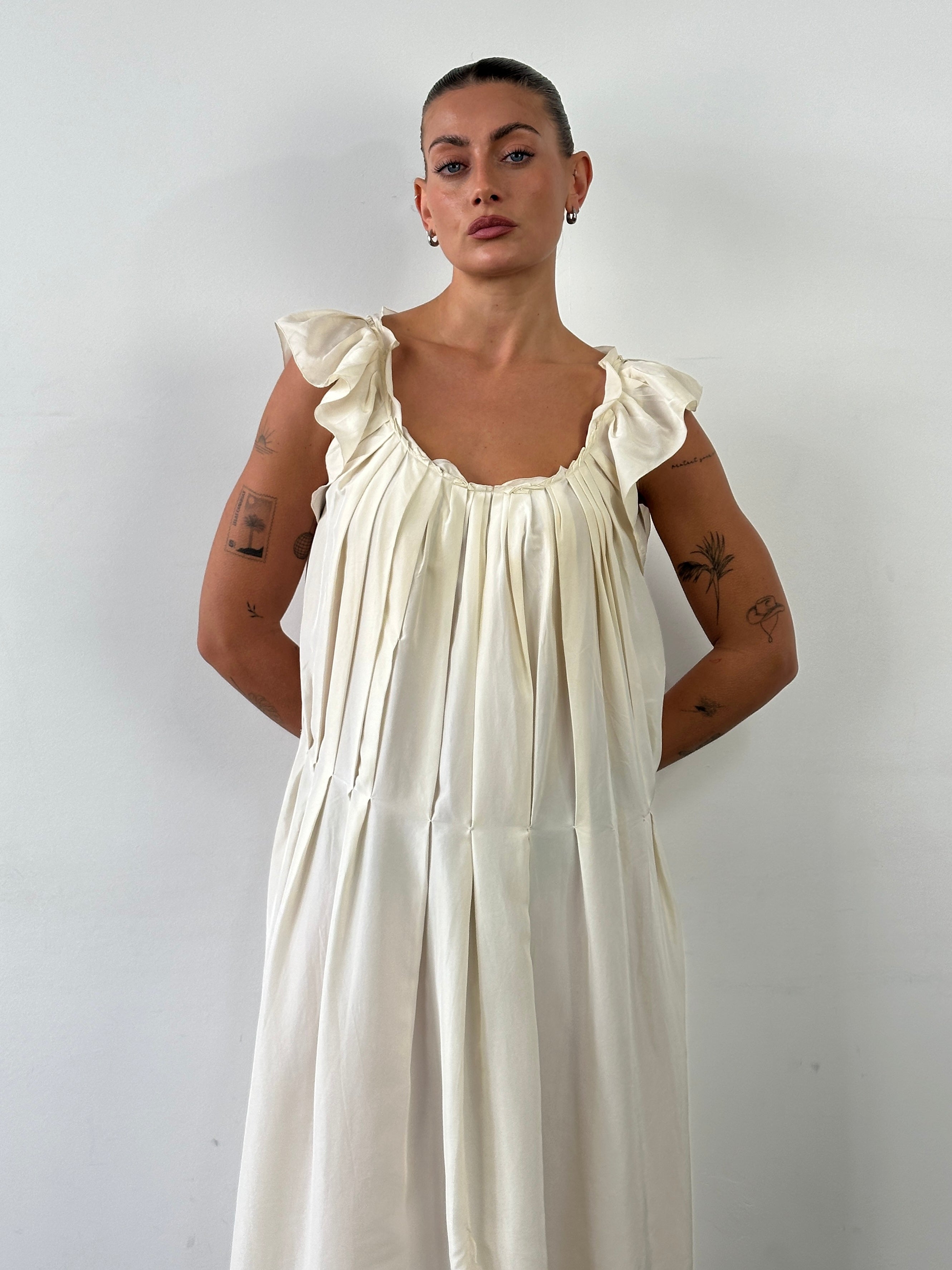 Prada 2012 pure silk pleated slip dress in size large, featuring a sleek, elegant design with fine pleats and smooth silk fabric.