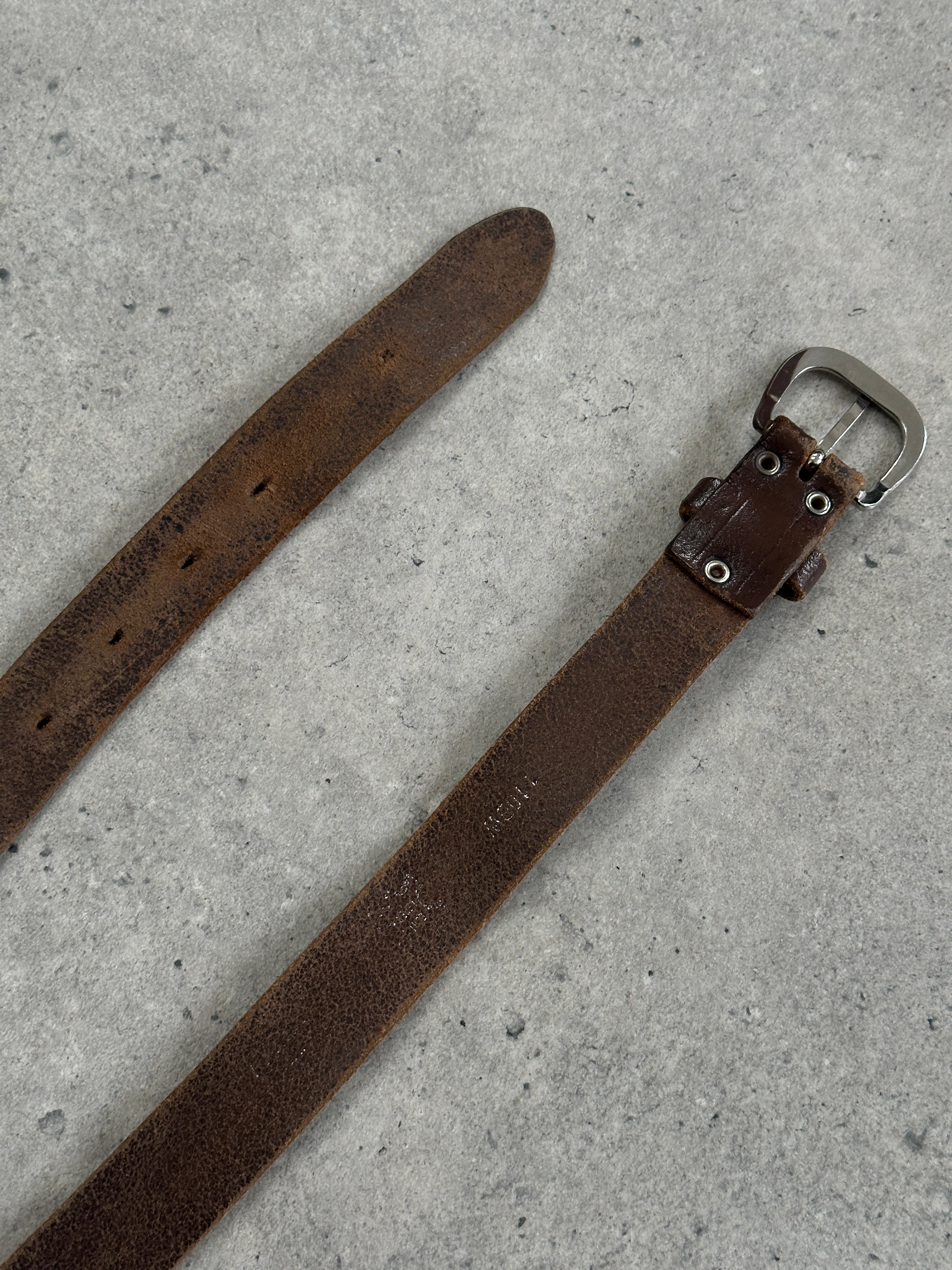 Vintage 1990s distressed slim leather belt with metal buckle, size W22-29 inches, featuring a worn, rugged leather design.