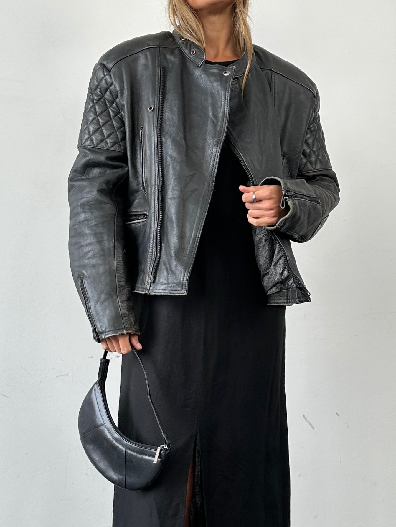 Vintage distressed motorcycle leather jacket in size L/XL, featuring a rugged design and classic style.