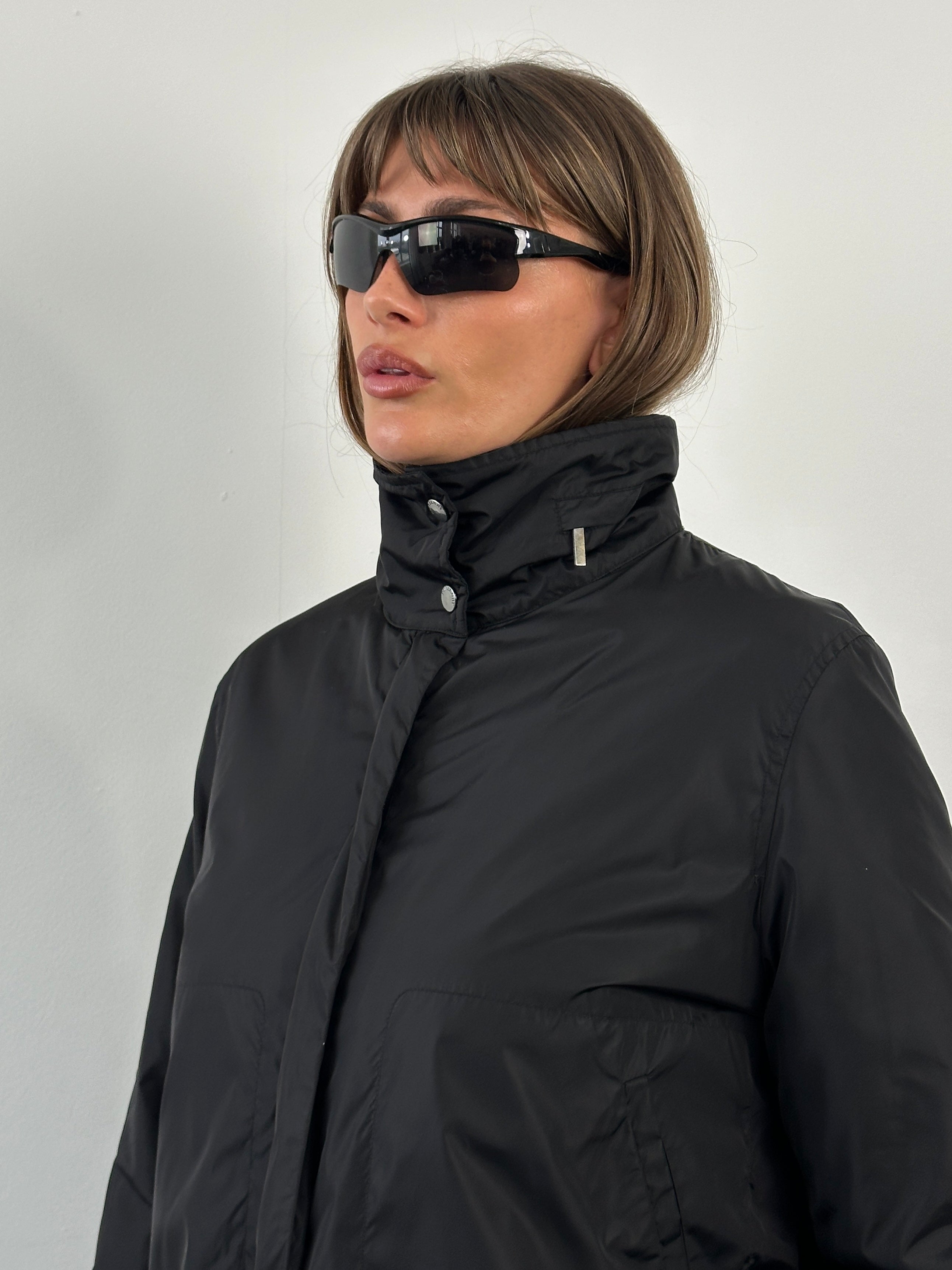 Burberry London 2000s nylon high neck jacket in size L, featuring a sleek high collar and lightweight nylon fabric.