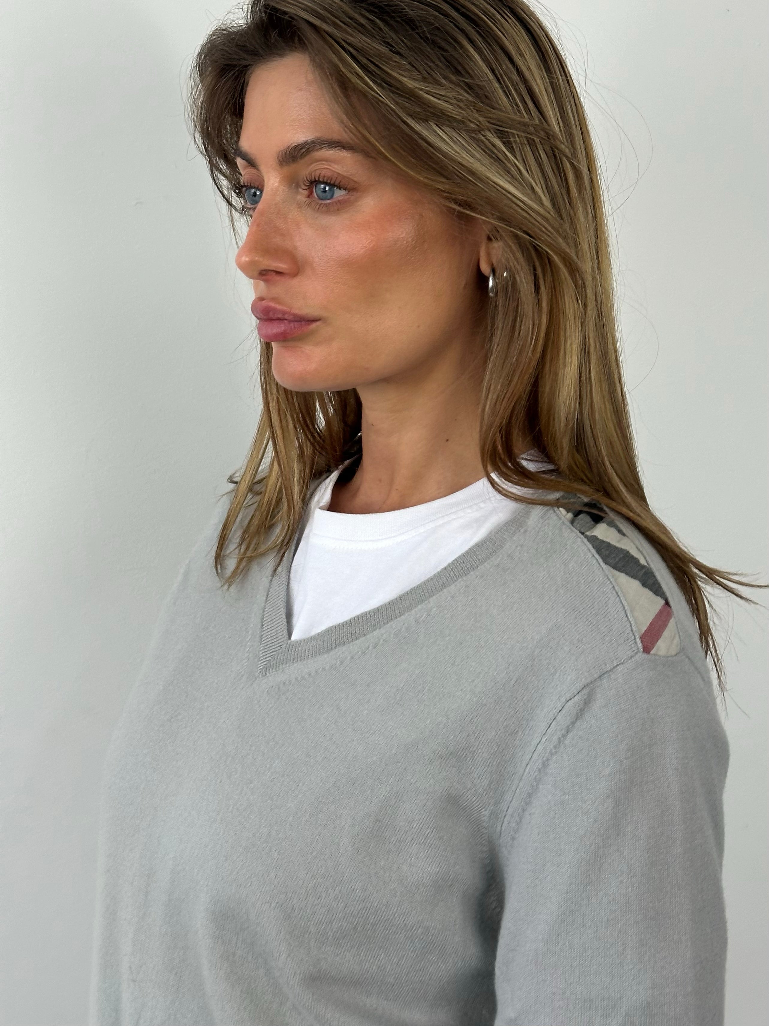Burberry Brit 2000s merino wool V-neck jumper in size M, featuring classic design and soft knit fabric.