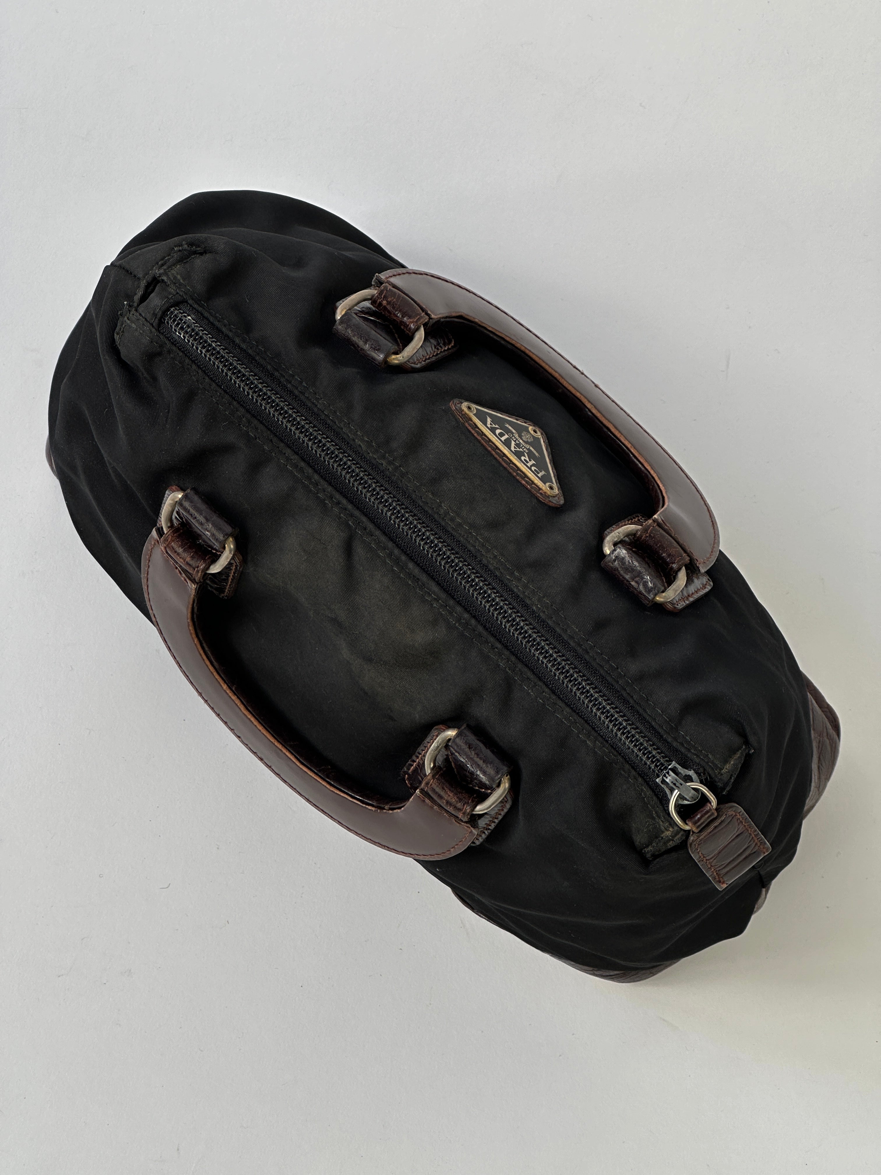 Prada nylon croc handbag with textured crocodile pattern and sleek design, featuring sturdy handles and elegant detailing.