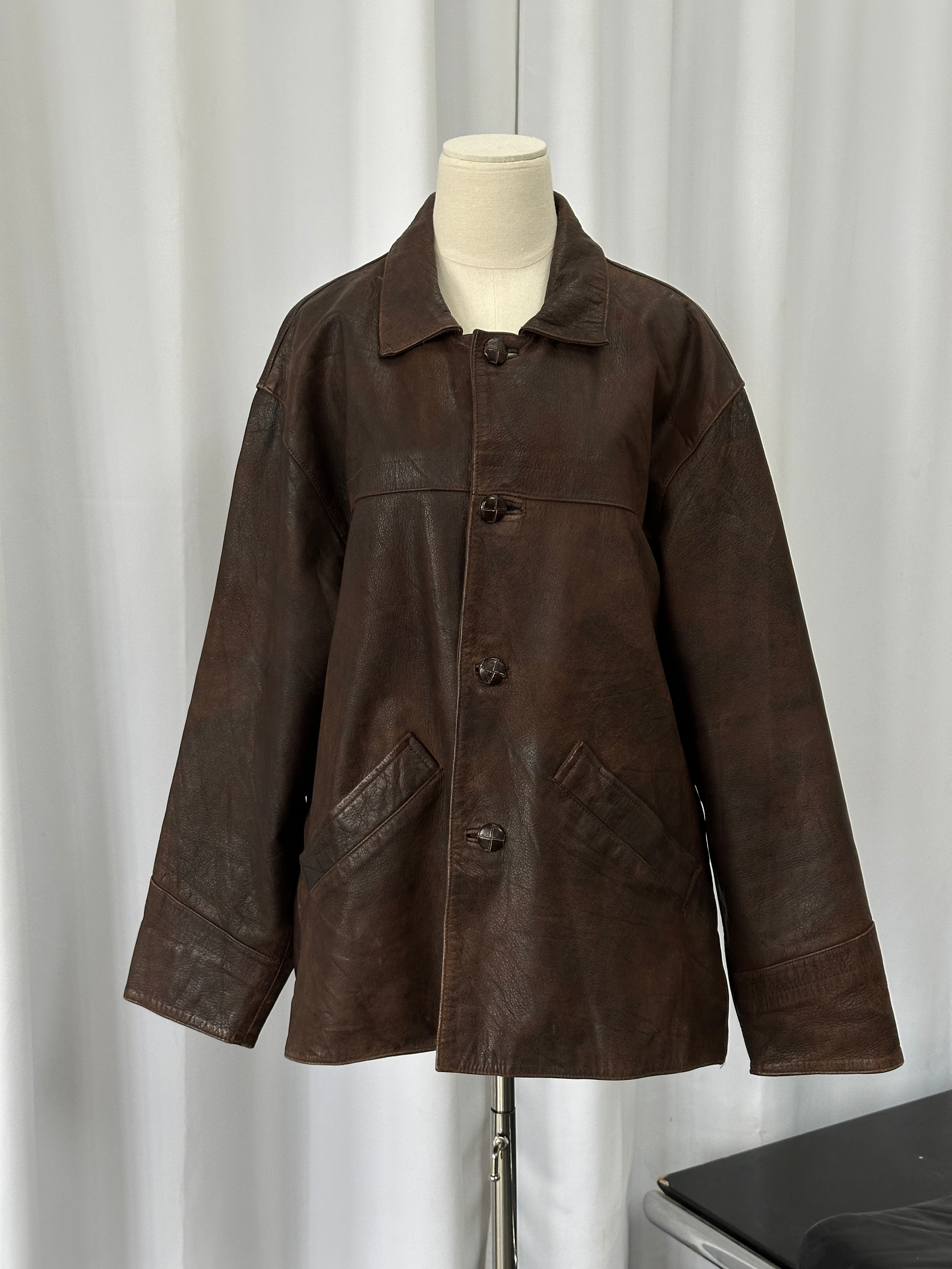 Vintage 1980s boxy leather jacket in aged brown leather, size XL, featuring classic vintage style and textured distressed leather.
