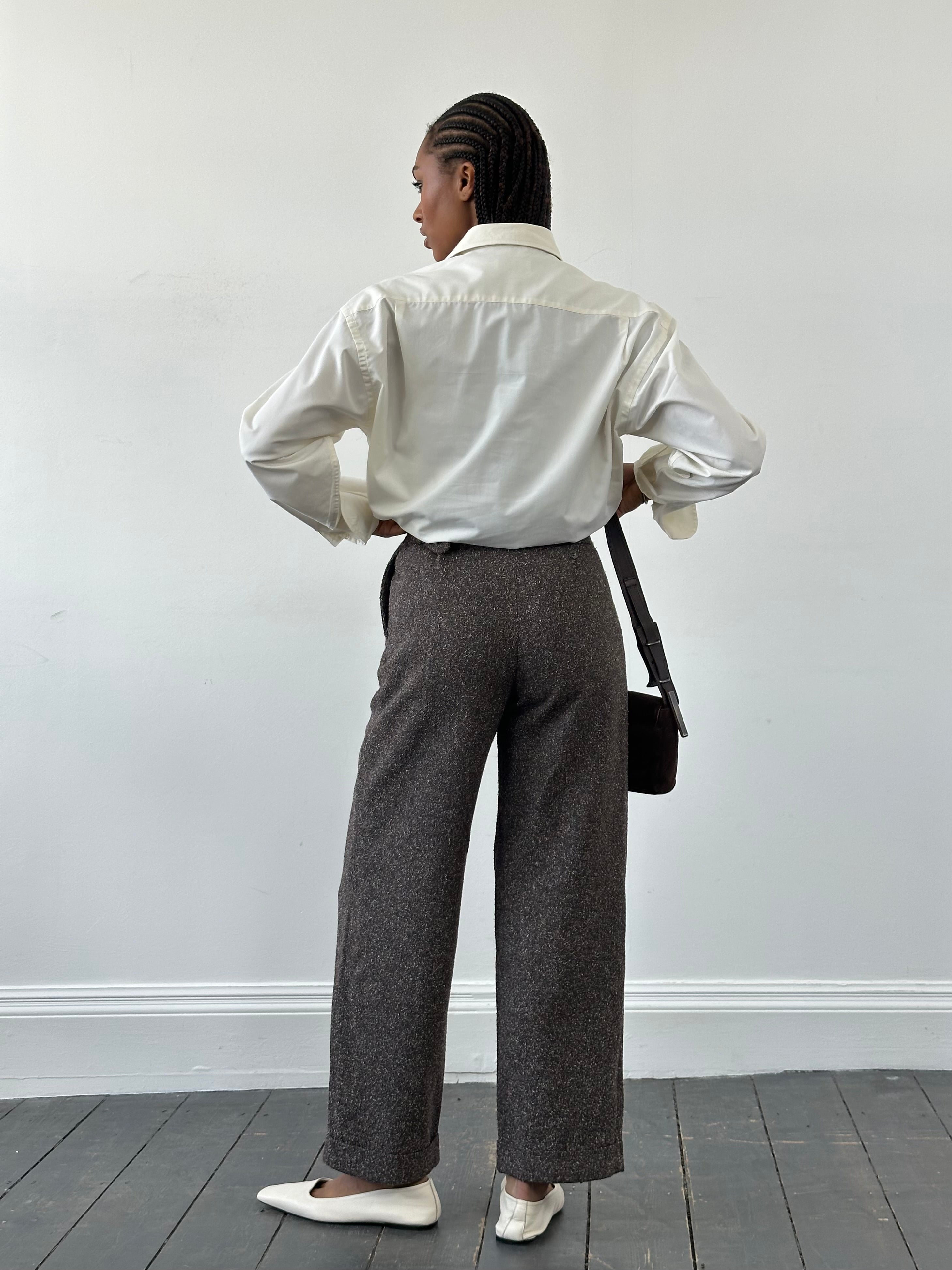Vintage closed 1990s high waisted wide leg trousers in W24 style, showcasing their classic fit and wide leg design.
