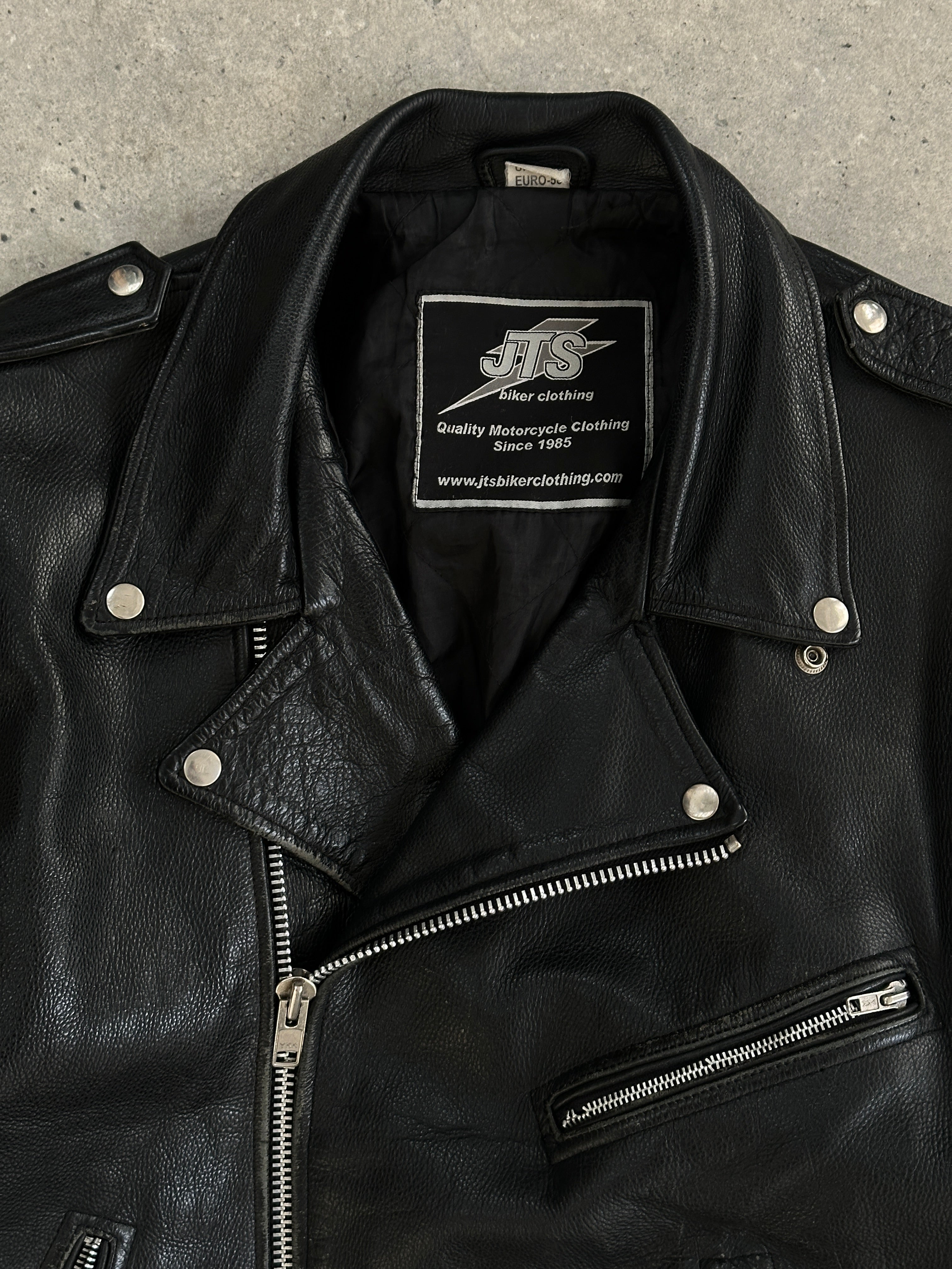 Vintage leather biker jacket in XL size with classic design and rugged style, featuring metal hardware and distressed finish.