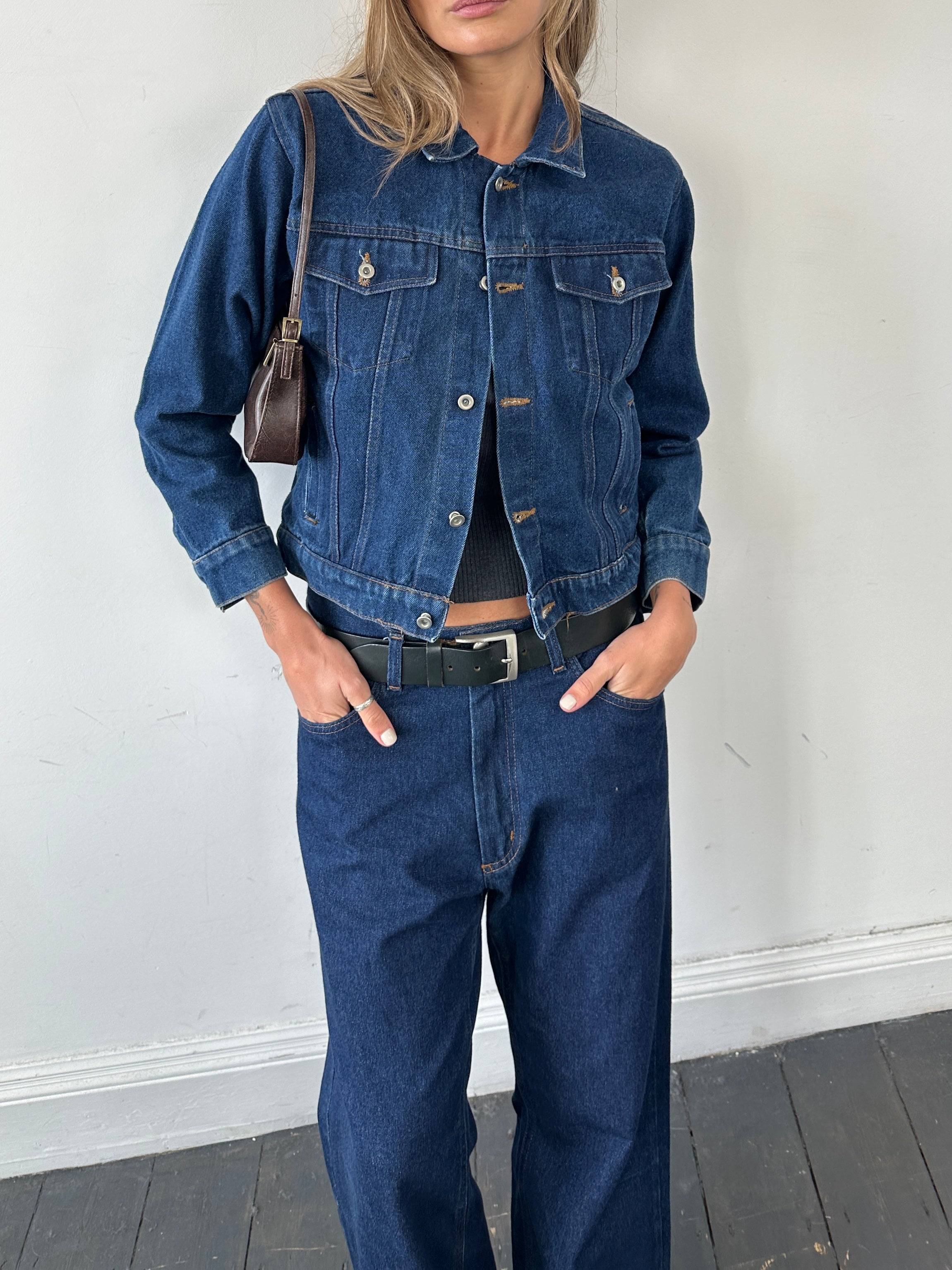 Vintage brand vintage button-up indigo denim jacket in XS/S size, showing front view with classic collar and button details.