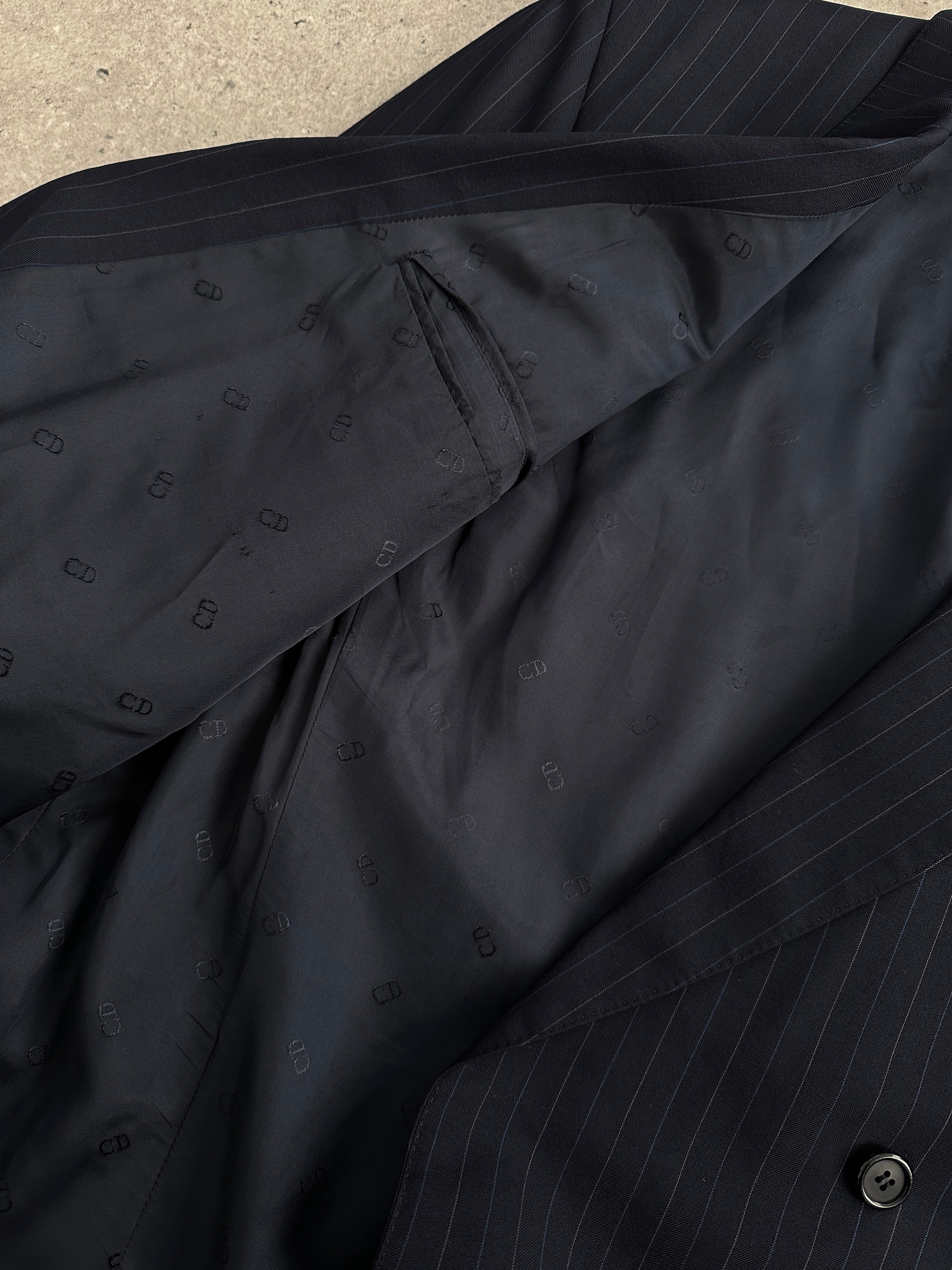 Christian Dior Monsieur pinstripe wool double-breasted suit, size 44S/W34, shown on a hanger with detailed fabric texture