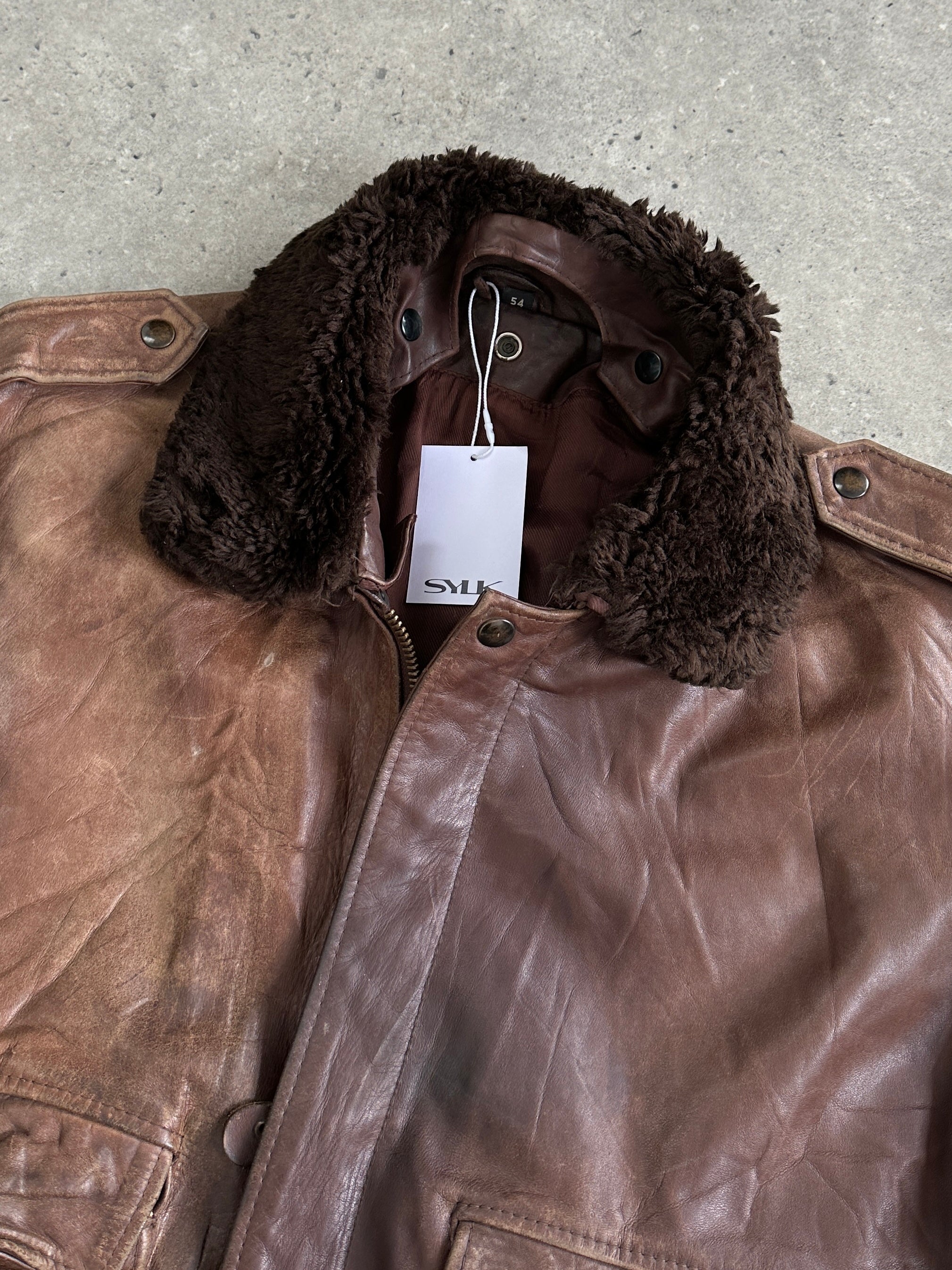 Vintage distressed leather bomber jacket in XL size with rugged style and classic design, featuring worn leather and casual fit.