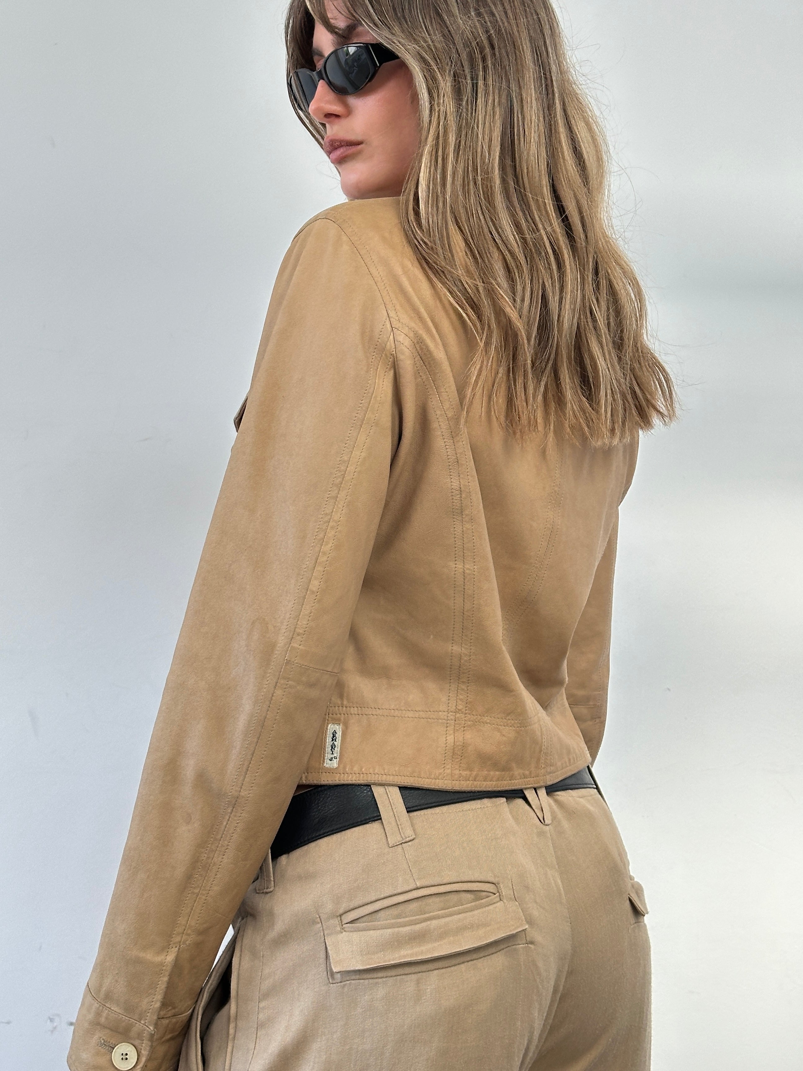 Armani Jeans fitted leather jacket from the 2000s, in size small, displayed on a hanger with visible details of the black leather.