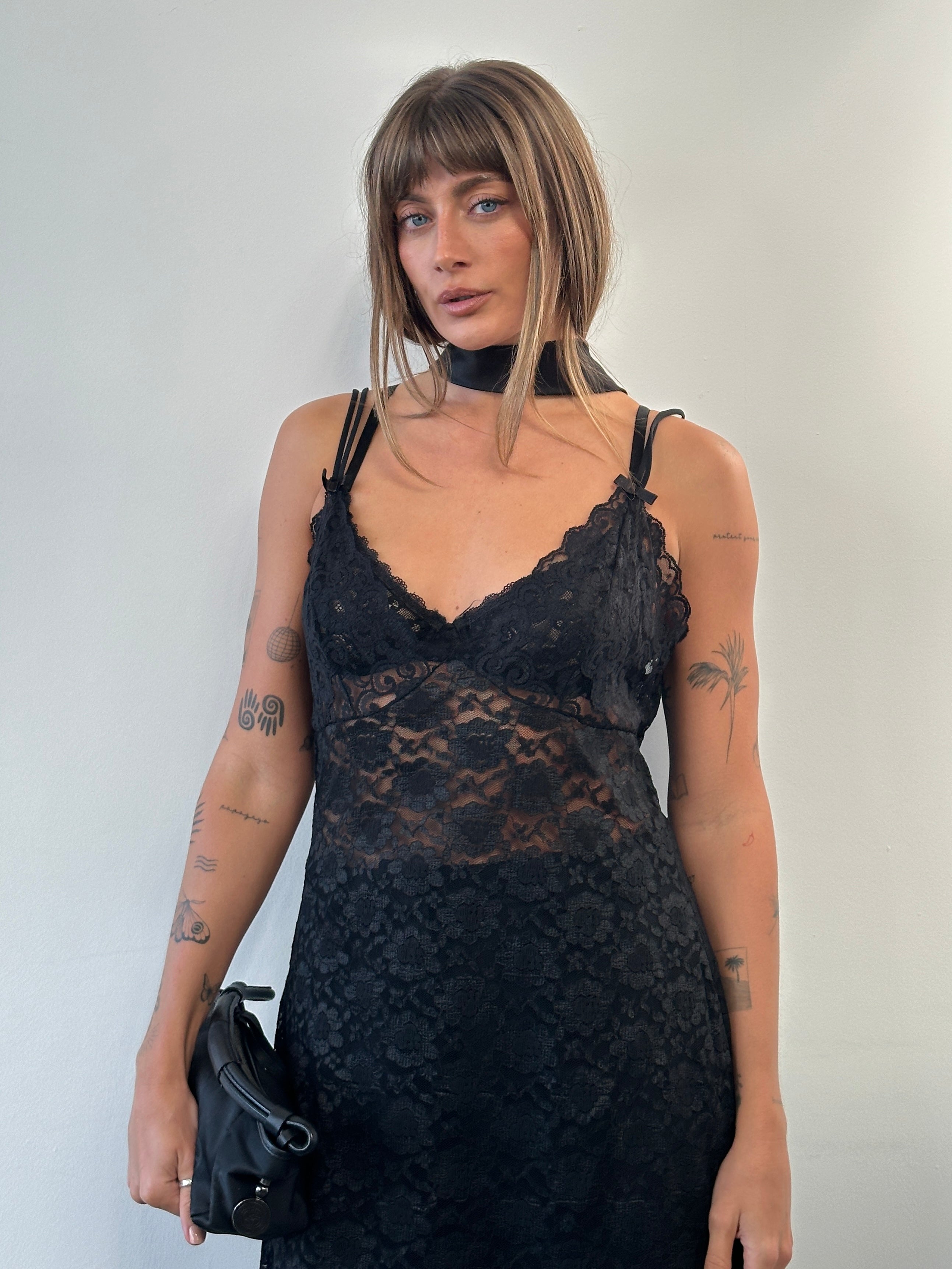 Vintage 1990s sheer lace mini slip dress in size large, featuring delicate lace details and a vintage-inspired design.