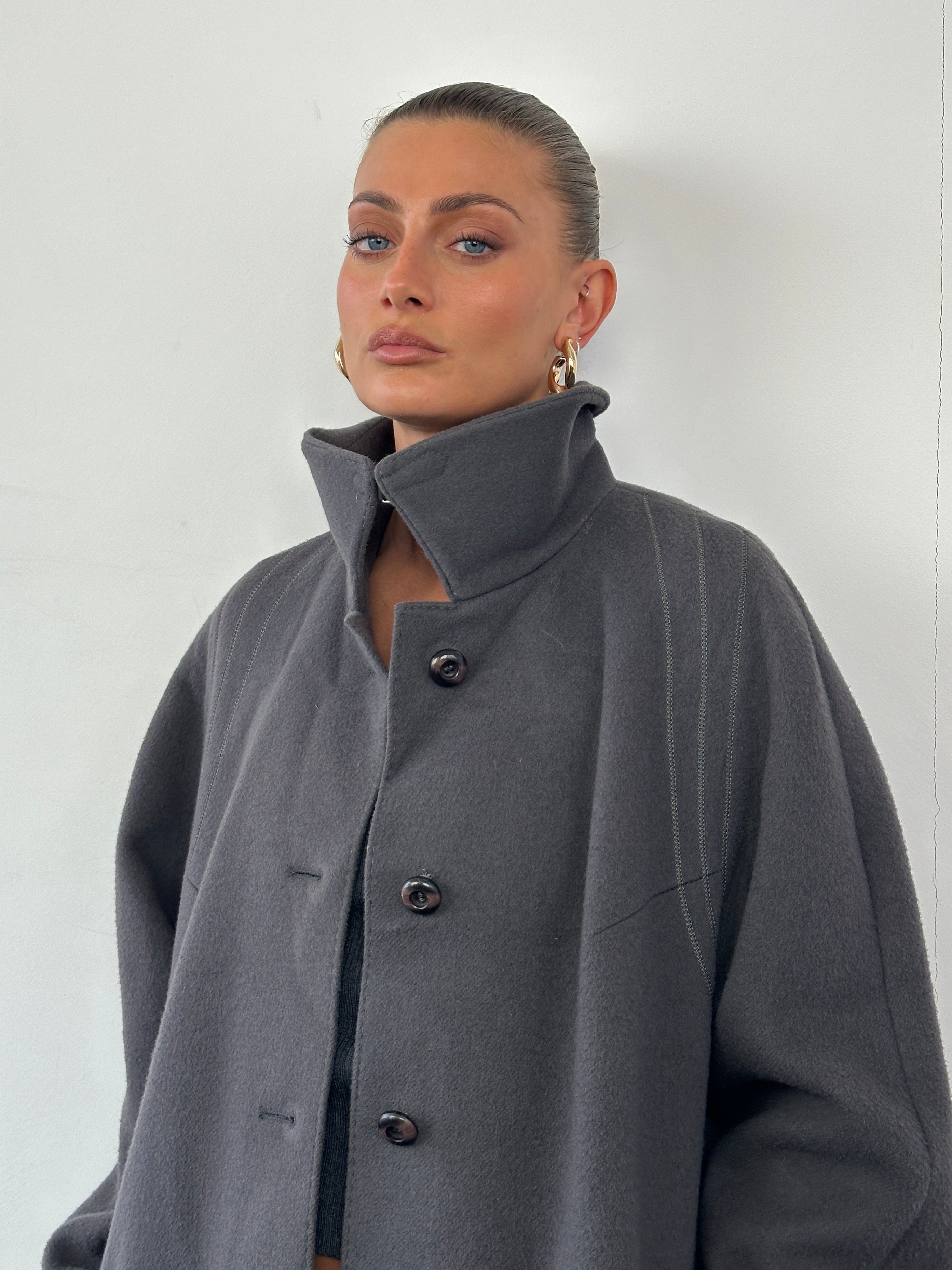 Vintage brand wool single-breasted coat in size M, shown in a classic vintage style with detailed collar and button closure.
