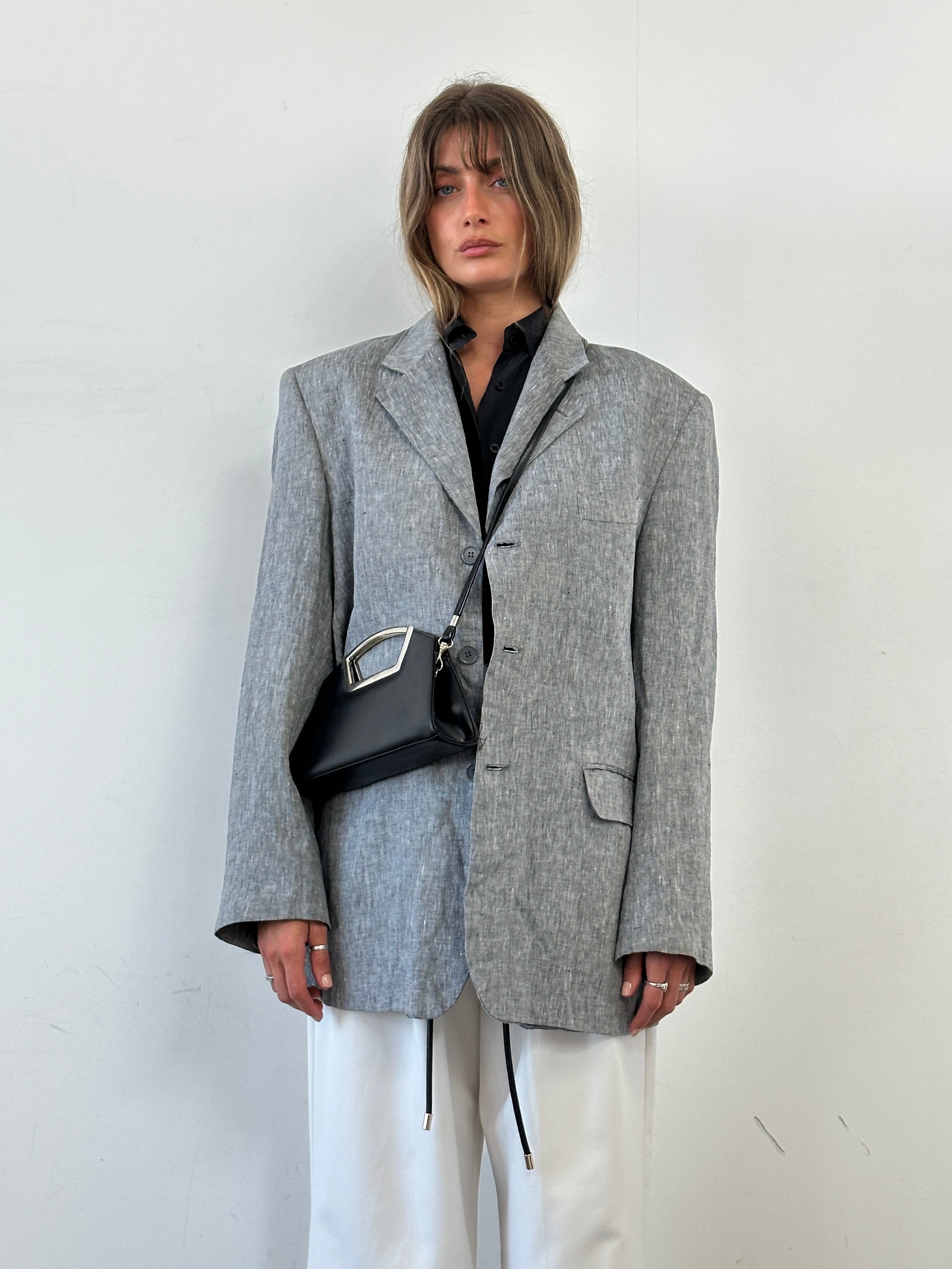 Vintage leather chrome crossbody clutch bag with adjustable strap, stylish and compact for everyday use.