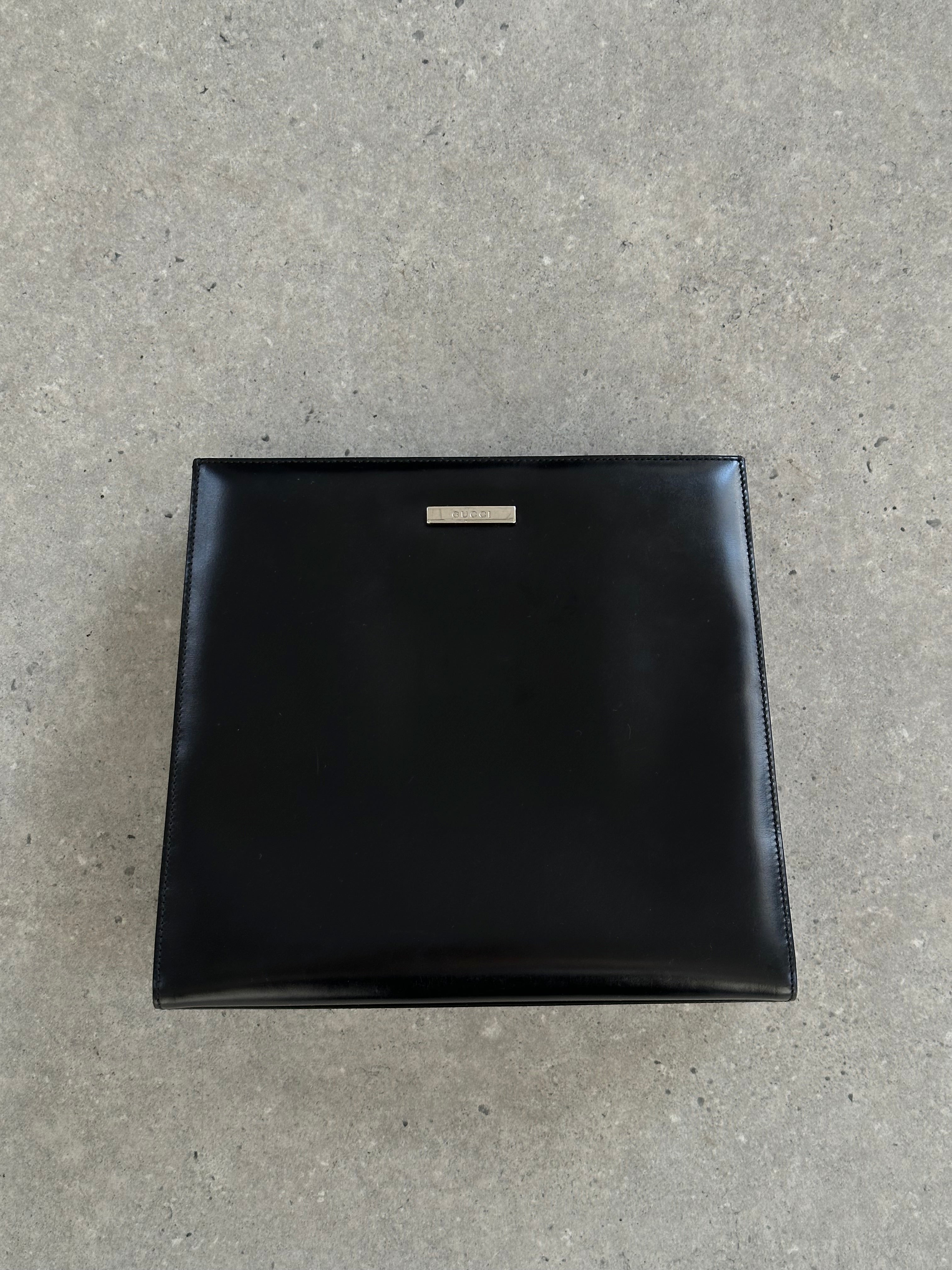 Gucci 1990s Tom Ford 2-in-1 leather and vinyl handbag with top handles and gold hardware, stylish and vintage-inspired design.